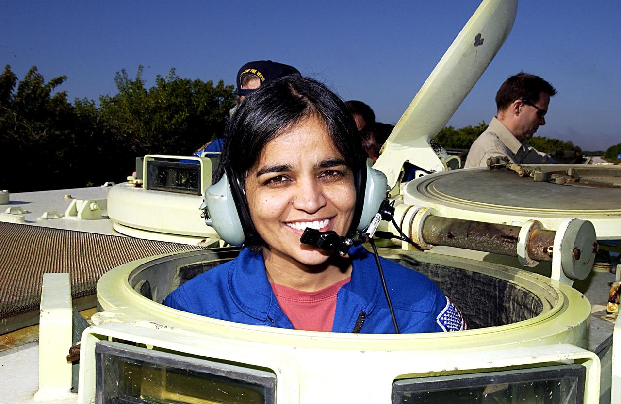 KENNEDY SPACE CENTER, FLA. --  STS-107 Mission Specialist Kalpana Chawla takes a break during training on the operation of an M113 armored personnel carrier during Terminal Countdown Demonstration Test activities, a standard part of launch preparations.  STS-107 is a mission devoted to research and will include more than 80 experiments that will study Earth and space science, advanced technology development, and astronaut health and safety.  Launch is planned for Jan. 16, 2003, between 10 a.m. and 2 p.m. EST aboard Space Shuttle Columbia.