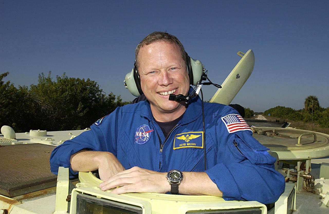 KENNEDY SPACE CENTER, FLA. --  -- STS-107 Mission Specialist David Brown takes a break during training on the operation of an M113 armored personnel carrier during Terminal Countdown Demonstration Test activities, a standard part of launch preparations. STS-107 is a mission devoted to research and will include more than 80 experiments that will study Earth and space science, advanced technology development, and astronaut health and safety. Launch is planned for Jan. 16, 2003, between 10 a.m. and 2 p.m. EST aboard Space Shuttle Columbia.