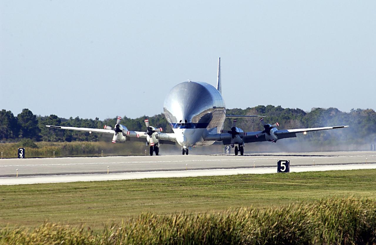KENNEDY SPACE CENTER, FLA. - - NASA's Super Guppy cargo airplane arrives at KSC carrying the Long Spacer (LS), the second and final piece of the Starboard 6 (S6) Integrated Truss Segment. After landing and offloading, the LS will be transported to the Space Station Processing Facility for inspections and verification tests. Eventually the LS will be integrated with the S6 Integrated Equipment Assembly already at KSC and will fly as one segment to the International Space Station on Space Shuttle mission STS-119 in early 2004. Together the segment pieces weigh 26,000 pounds and measure 45 feet long. .