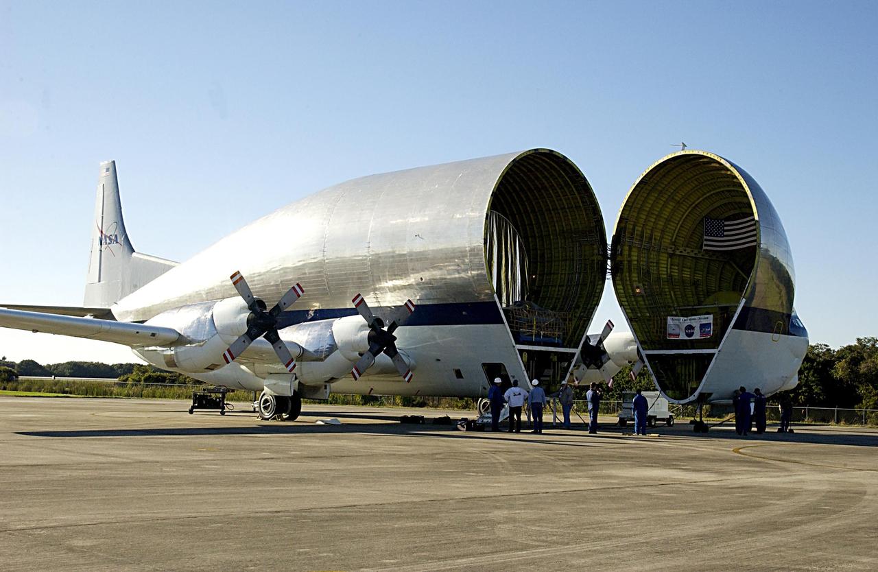 KENNEDY SPACE CENTER, FLA. - After landing at the KSC Shuttle Landing Facility, NASA's Super Guppy cargo airplane opens to remove its cargo, the Long Spacer (LS), the second and final piece of the Starboard 6 (S6) Integrated Truss Segment. The LS will be transported to the Space Station Processing Facility for inspections and verification tests. Eventually the LS will be integrated with the S6 Integrated Equipment Assembly already at KSC and will fly as one segment to the International Space Station on Space Shuttle mission STS-119 in early 2004. Together the segment pieces weigh 26,000 pounds and measure 45 feet long. .