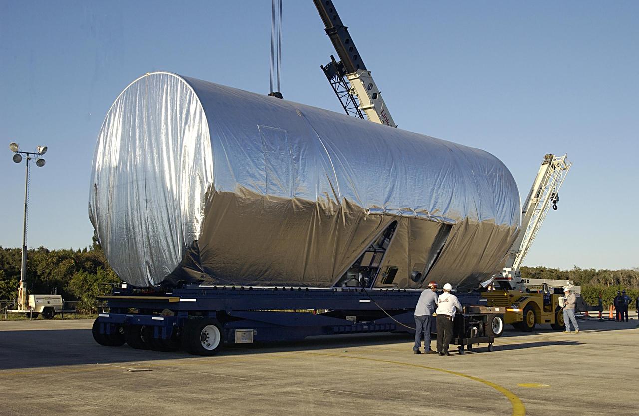 KENNEDY SPACE CENTER, FLA. -- The Long Spacer (LS), the second and final piece of the Starboard 6 (S6) Integrated Truss Segment, is secured on a flatbed truck for transport to the Space Station Processing Facility where it will undergo inspections and verification tests. Eventually the LS will be integrated with the S6 Integrated Equipment Assembly already at KSC and will fly as one segment to the International Space Station on Space Shuttle mission STS-119 in early 2004. Together the segment pieces weigh 26,000 pounds and measure 45 feet long. .