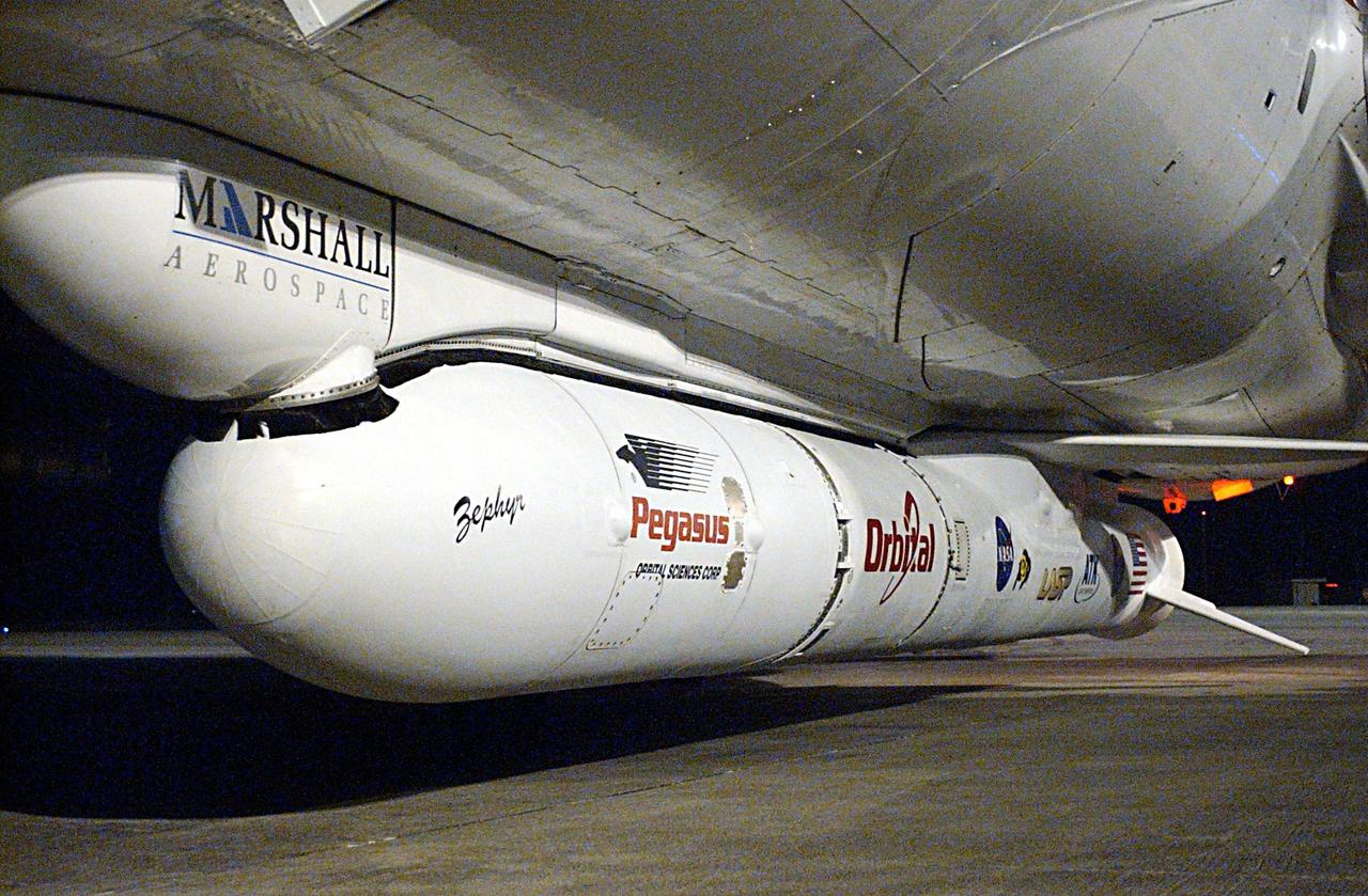 KENNEDY SPACE CENTER, FLA. -- Attached underneath the Orbital Sciences L-1011 aircraft is the Pegasus XL Expendable Launch Vehicle, which will be transported to the Multi-Payload Processing Facility for testing and verification. The Pegasus will undergo three flight simulations prior to its scheduled launch in late January 2003. The Pegasus XL will carry NASA's Solar Radiation and Climate Experiment (SORCE) into orbit. Built by Orbital Sciences Space Systems Group, SORCE will study and measure solar irradiance as a source of energy in the Earth's atmosphere. .