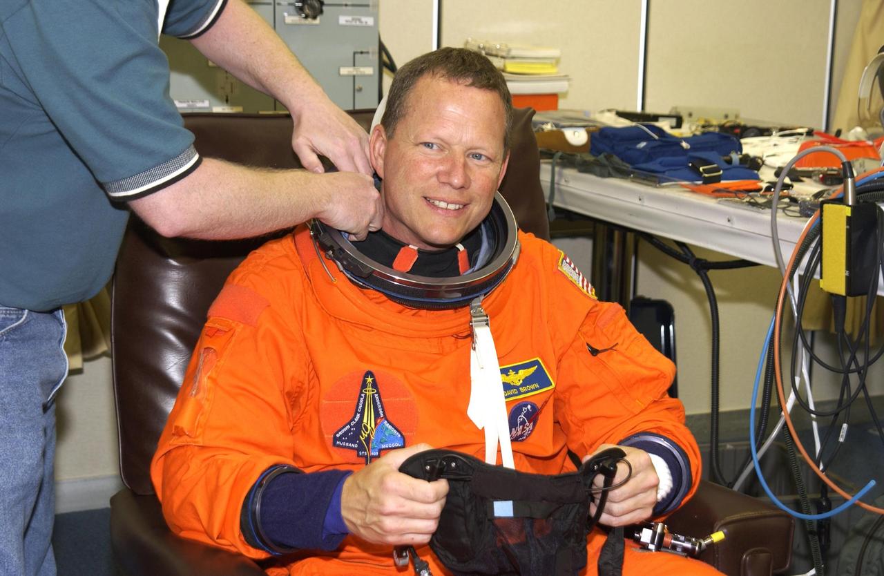 KENNEDY SPACE CENTER, FLA. -- STS-107 Mission Specialist David Brown happily submits to suit check prior to Terminal Countdown Demonstration Test activities, which include a simulated launch countdown at the pad. STS-107 is a mission devoted to research and will include more than 80 experiments that will study Earth and space science, advanced technology development, and astronaut health and safety. Launch is planned for Jan. 16, 2003, between 10 a.m. and 2 p.m. EST aboard Space Shuttle Columbia. .