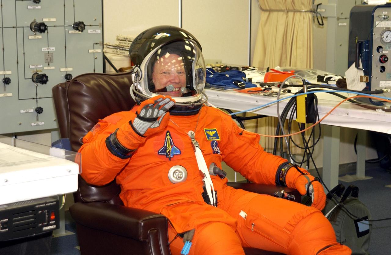 KENNEDY SPACE CENTER, FLA. -- STS-107 Mission Specialist David Brown waves as he completes suit check prior to Terminal Countdown Demonstration Test activities, which include a simulated launch countdown at the pad. STS-107 is a mission devoted to research and will include more than 80 experiments that will study Earth and space science, advanced technology development, and astronaut health and safety. Launch is planned for Jan. 16, 2003, between 10 a.m. and 2 p.m. EST aboard Space Shuttle Columbia. .