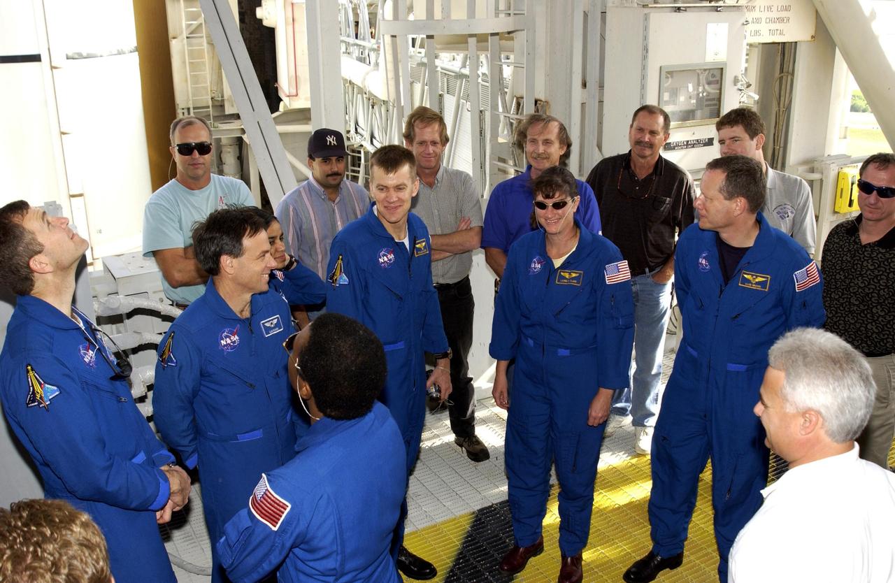 KENNEDY SPACE CENTER, FLA. - The STS-107 crew share a humorous moment on Launch Pad 39A during Terminal Countdown Demonstration Test activities.  From left are Commander Rick Husband, Payload Specialist Ilan Ramon (the first Israeli astronaut), Pilot William "Willie" McCool, Mission Specialists Lauarel Clark and David Brown; in the foreground (back to camera) is Payload Commander Michael Anderson. The TCDT also includes a simulated launch countdown.  STS-107 is a mission devoted to research and will include more than 80 experiments that will study Earth and space science, advanced technology development, and astronaut health and safety. Launch is planned for Jan. 16, 2003, between 10 a.m. and 2 p.m. EST aboard Space Shuttle Columbia.    .  