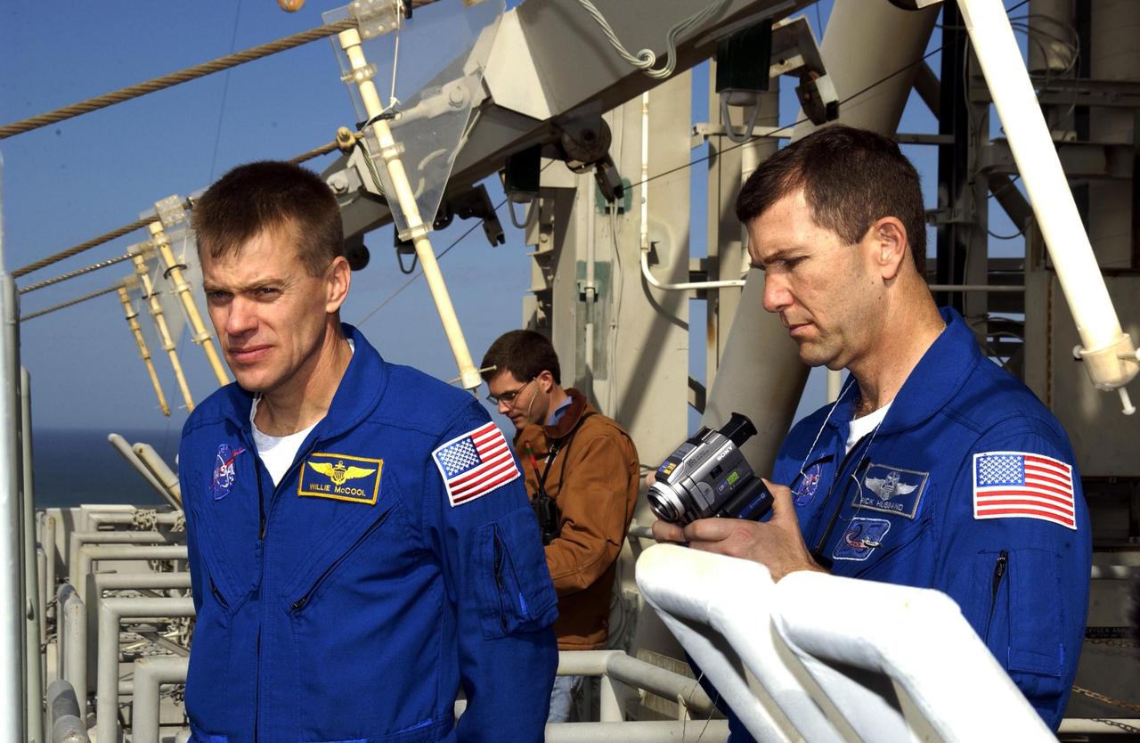 KENNEDY SPACE CENTER, FLA. -- The STS-107 crew gets instruction on emergency egress from the pad during Terminal Countdown Demonstration Test activities.  Seen are Pilot William "Willie" McCool and Commander Rick Husband. The TCDT also includes a simulated launch countdown.  STS-107 is a mission devoted to research and will include more than 80 experiments that will study Earth and space science, advanced technology development, and astronaut health and safety. Launch is planned for Jan. 16, 2003, between 10 a.m. and 2 p.m. EST aboard Space Shuttle Columbia.    .  