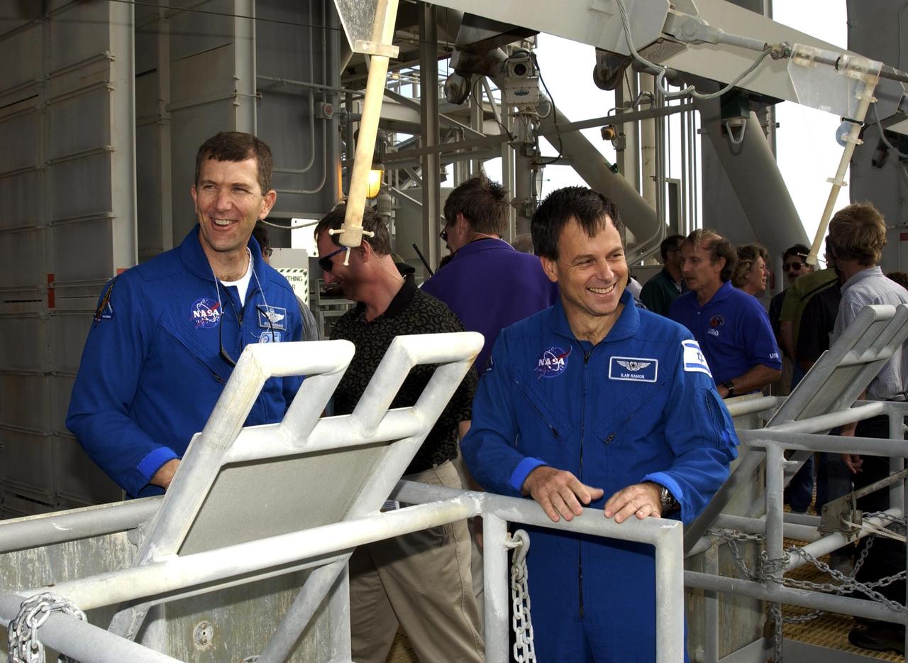 KENNEDY SPACE CENTER, FLA. -- Sharing a humorous moment on Launch Pad 39A during Terminal Countdown Demonstration Test activities are (left) Commander Rick Husband and (right) Payload Specialist Ilan Ramon (the first Israeli astronaut). The TCDT also includes a simulated launch countdown.  STS-107 is a mission devoted to research and will include more than 80 experiments that will study Earth and space science, advanced technology development, and astronaut health and safety. Launch is planned for Jan. 16, 2003, between 10 a.m. and 2 p.m. EST aboard Space Shuttle Columbia.    .  
