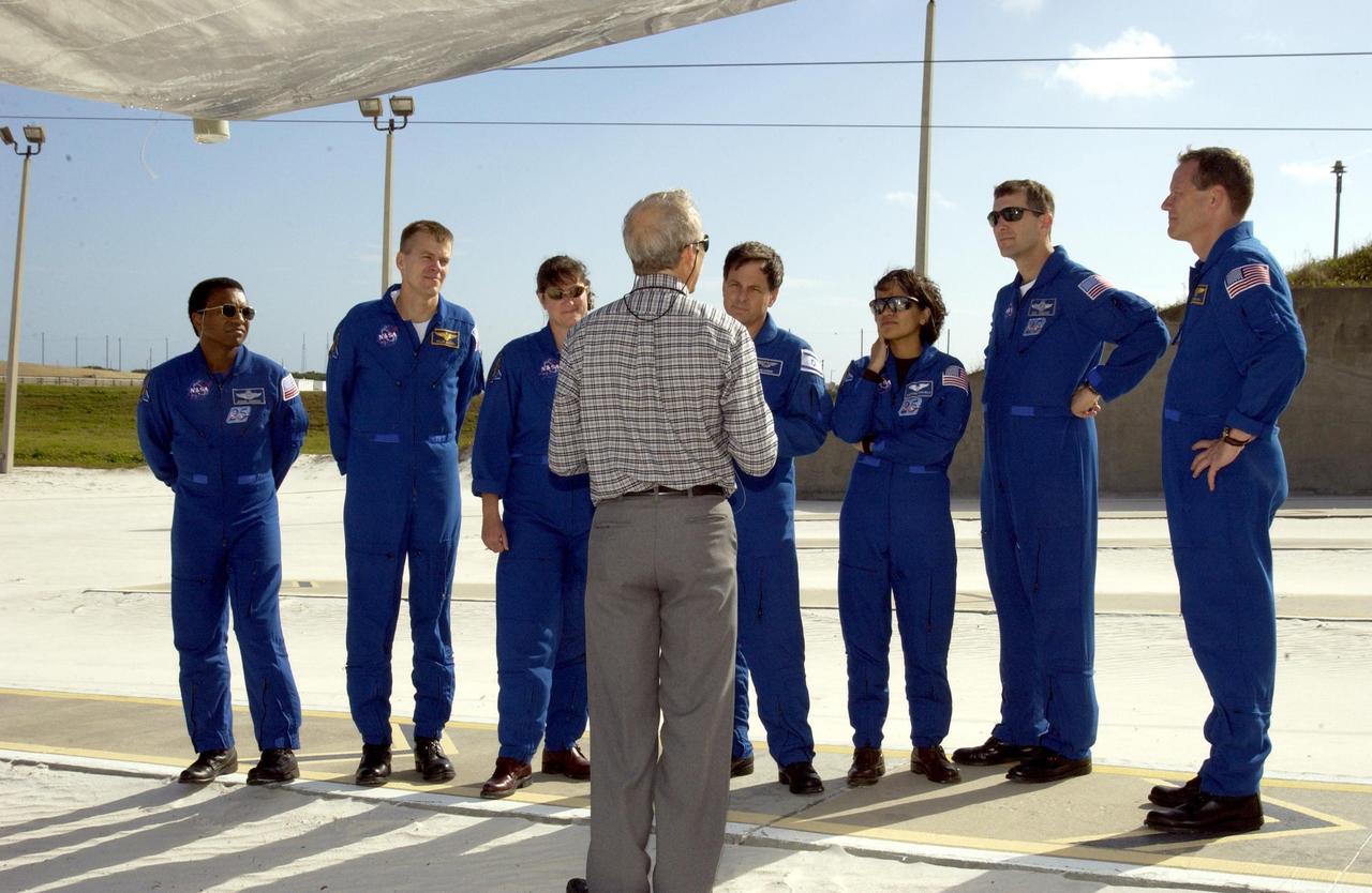 KENNEDY SPACE CENTER, FLA. - In the emergency egress landing site on Launch Pad 39A, the STS-107 crew listens to instructions.  Standing from left are Payload Commander Michael Anderson, Pilot William "Willie" McCool, Mission Specialists Laurel Clark, Ilan Ramon and Kalpana Chawla, Commander Rick Husband and Mission Specialist David Brown.  Ramon is the first Israeli astronaut.  The crew is taking part in Terminal Countdown Demonstration Test activities at the pad, which also include a simulated launch countdown. STS-107 is a mission devoted to research and will include more than 80 experiments that will study Earth and space science, advanced technology development, and astronaut health and safety. Launch is planned for Jan. 16, 2003, between 10 a.m. and 2 p.m. EST aboard Space Shuttle Columbia.    .  