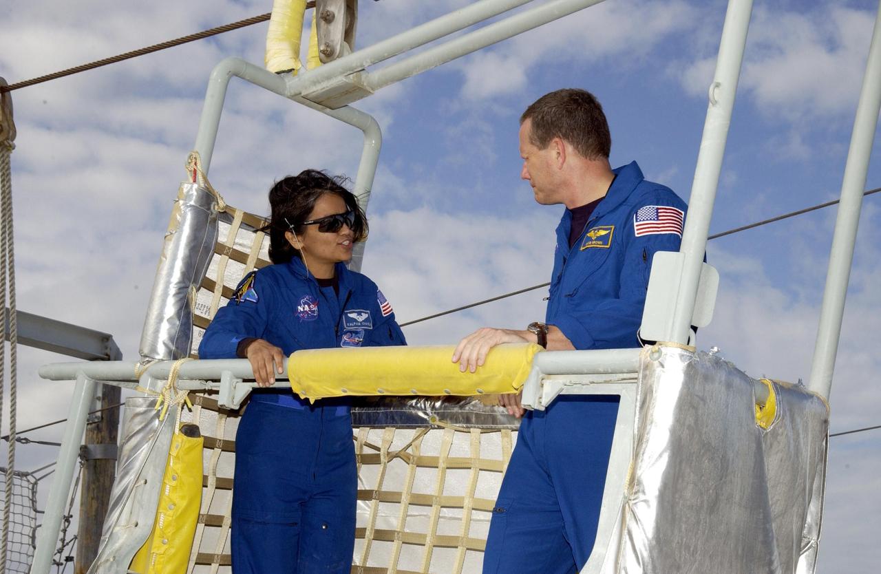 KENNEDY SPACE CENTER, FLA. -- During emergency egress training, part of Terminal Countdown Demonstration Test activities at the pad, STS-107 Mission Specialists Kalpana Chawla and David Brown share a slidewire basket. The TCDT also includes a simulated launch countdown.  STS-107 is a mission devoted to research and will include more than 80 experiments that will study Earth and space science, advanced technology development, and astronaut health and safety. Launch is planned for Jan. 16, 2003, between 10 a.m. and 2 p.m. EST aboard Space Shuttle Columbia.    .  