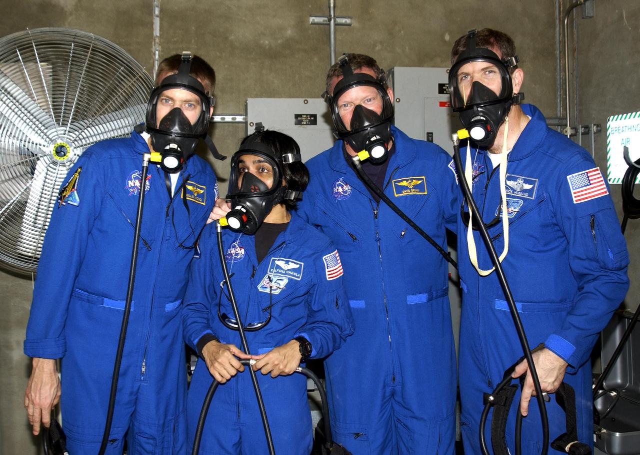KENNEDY SPACE CENTER, FLA. -- During emergency egress training, part of Terminal Countdown Demonstration Test activities at the pad, STS-107 crew members test breathing masks in the emergency bunker.  From left are Pilot William "Willie" McCool, Mission Specialists Kalpana Chawla and David Brown, and Commander Rick Husband. STS-107 is a mission devoted to research and will include more than 80 experiments that will study Earth and space science, advanced technology development, and astronaut health and safety. Launch is planned for Jan. 16, 2003, between 10 a.m. and 2 p.m. EST aboard Space Shuttle Columbia.    .  