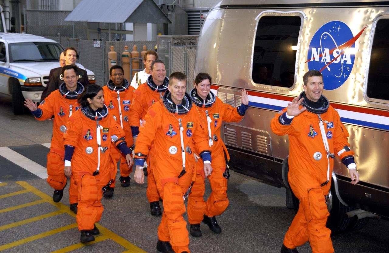KENNEDY SPACE CENTER, FLA. - The STS-107 crew heads for the Astrovan and a ride to Launch Pad 39A for a simulated launch countdown.  From left are Payload Specialist Ilan Ramon, Mission Specialist Kalpana Chawla, Payload Commander Michael Anderson, Mission Specialist David Brown, Pilot William "Willie" McCool, Mission Specialist Laurel Clark and Commander Rick Husband.  The countdown is part of Terminal Countdown Demonstration Test activities. STS-107 is a mission devoted to research and will include more than 80 experiments that will study Earth and space science, advanced technology development, and astronaut health and safety. Launch is planned for Jan. 16, 2003, between 10 a.m. and 2 p.m. EST aboard Space Shuttle Columbia.    .  
