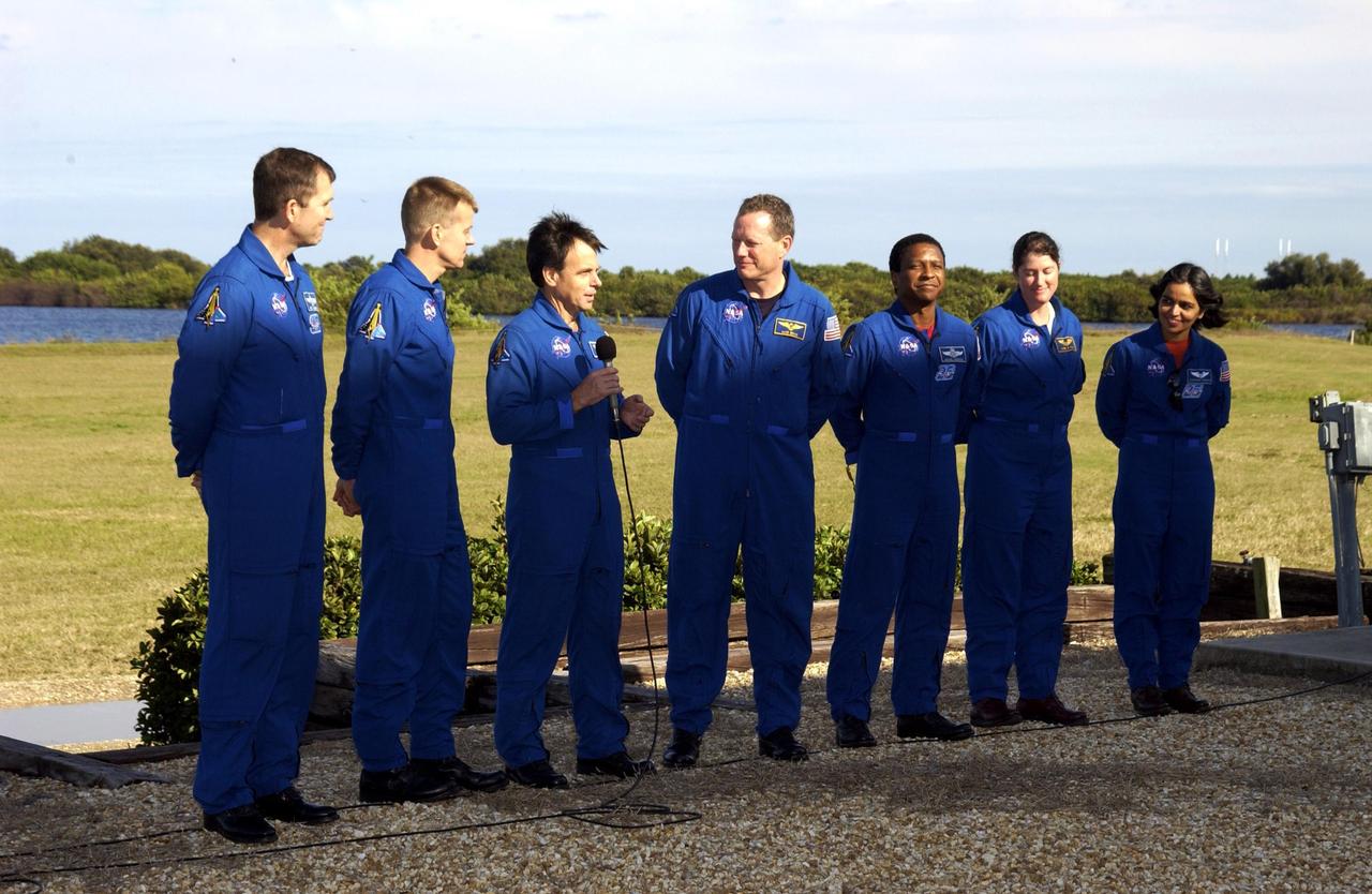 KENNEDY SPACE CENTER, FLA. -- The STS-107 crew meet with the media in front of the grandstand. With the microphone is Payload Specialist Ilan Ramon, the first Israeli astronaut.  Others, from left, are Commander Rick Husband, Pilot William "Willie" McCool, Ramon, Mission Specialist David Brown, Payload Commander Michael Anderson, and Mission Specialists Laurel Clark and Kalpana Chawla.  The crew just finished Terminal Countdown Demonstration Test activities, including a simulated launch countdown, in preparation for launch planned for Jan. 16, 2003, between 10 a.m. and 2 p.m. EST aboard Space Shuttle Columbia. STS-107 is a mission devoted to research and will include more than 80 experiments that will study Earth and space science, advanced technology development, and astronaut health and safety.        .  