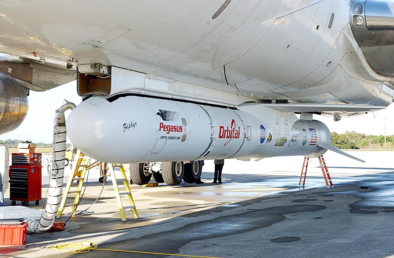 KENNEDY SPACE CENTER, FLA. -- A Pegasus XL Expendable Launch Vehicle is moments away from being removed from the underside of an Orbital Sciences L-1011 aircraft.  The aircraft, with the launch vehicle attached, arrived at the Cape Canaveral Air Force Station Skid Strip on Dec. 17. The Pegasus XL will undergo three flight simulations prior to its scheduled launch in late January 2003.  It will carry NASA's Solar Radiation and Climate Experiment (SORCE) spacecraft into orbit. Built by Orbital Sciences Space Systems Group, SORCE will study and measure solar irradiance as a source of energy in the Earth's atmosphere with instruments built by the University of Colorado's Laboratory for Atmospheric and Space Physics (LASP).   
