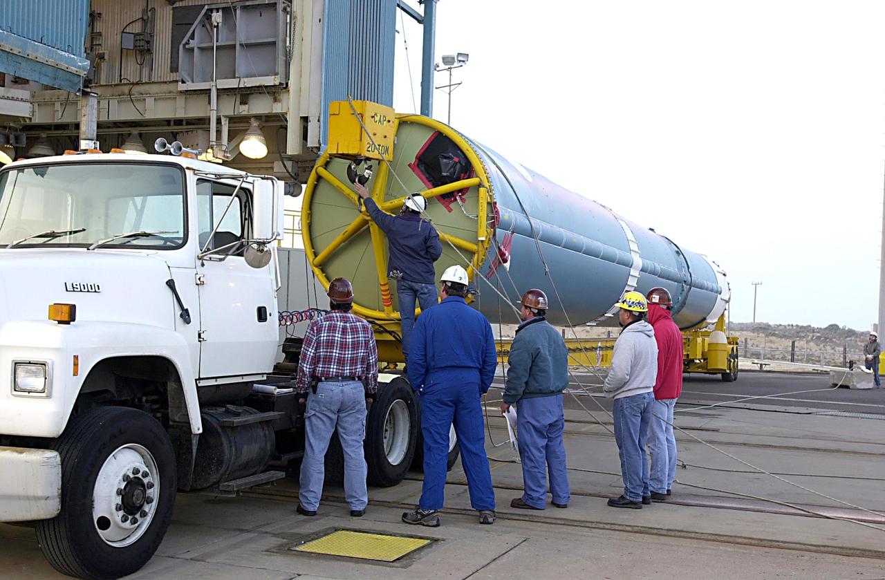 KENNEDY SPACE CENTER, FLA. - The first stage of a Delta II rocket arrives at NASA's Space Launch Complex 2 (SLC-2) at Vandenberg Air Force Base, Calif. The rocket will carry the ICESat and CHIPSat satellites into Earth orbits. ICESat is a 661-pound satellite known as Geoscience Laser Altimeter System (GLAS) that will revolutionize our understanding of ice and its role in global climate change and how we protect and understand our home planet. It will help scientists determine if the global sea level is rising or falling. It will look at the ice sheets that blanket the Earth's poles to see if they are growing or shrinking. It will assist in developing an understanding of how changes in the Earth's atmosphere and climate effect polar ice masses and global sea level. CHIPSat, a suitcase-size 131-pound satellite, will provide invaluable information into the origin, physical processes and properties of the hot gas contained in the interstellar medium. This can provide important clues about the formation and evolution of galaxies since the interstellar medium literally contains the seeds of future stars. The Delta II launch is scheduled for Jan. 11 between 4:45 p.m. - 5:30 p.m. PST.