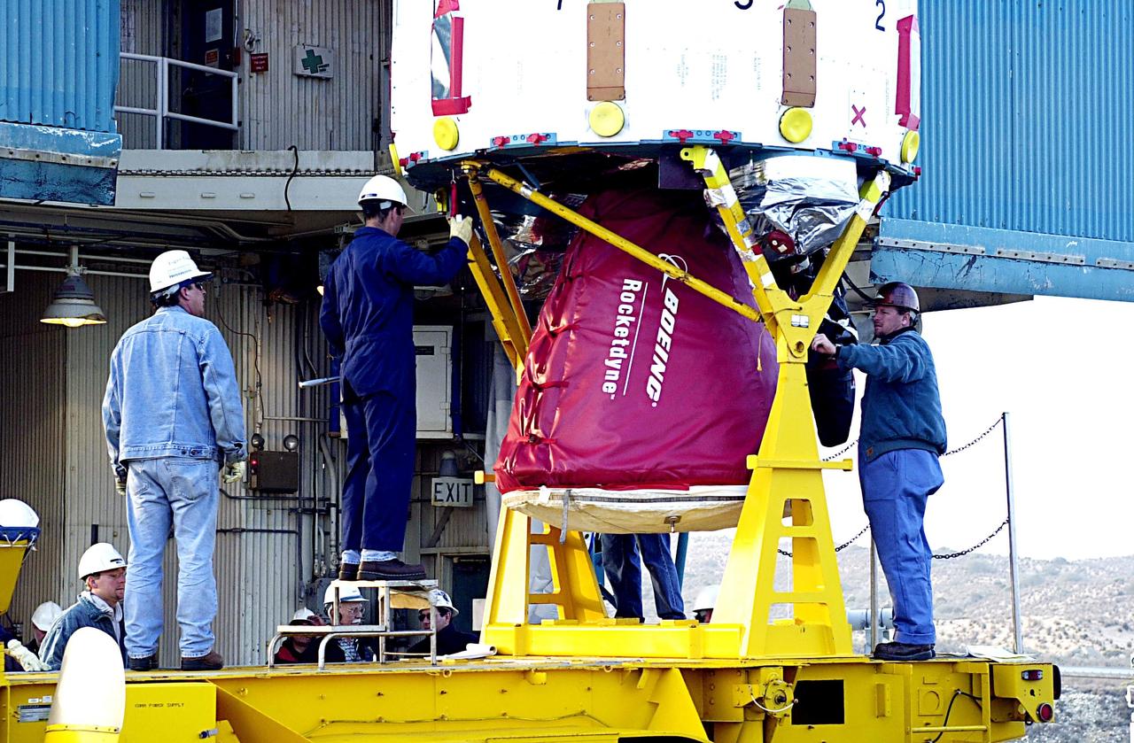 KENNEDY SPACE CENTER, FLA. - Workers check the lower end of the first stage of the Delta II rocket before it is lifted up the tower on NASA's Space Launch Complex 2 (SLC-2), Vandenberg Air Force Base, Calif. The rocket will carry the ICESat and CHIPSat satellites into Earth orbits. ICESat is a 661-pound satellite known as Geoscience Laser Altimeter System (GLAS) that will revolutionize our understanding of ice and its role in global climate change and how we protect and understand our home planet. It will help scientists determine if the global sea level is rising or falling. It will look at the ice sheets that blanket the Earth's poles to see if they are growing or shrinking. It will assist in developing an understanding of how changes in the Earth's atmosphere and climate effect polar ice masses and global sea level. CHIPSat, a suitcase-size 131-pound satellite, will provide invaluable information into the origin, physical processes and properties of the hot gas contained in the interstellar medium. This can provide important clues about the formation and evolution of galaxies since the interstellar medium literally contains the seeds of future stars. The Delta II launch is scheduled for Jan. 11 between 4:45 p.m. - 5:30 p.m. PST.