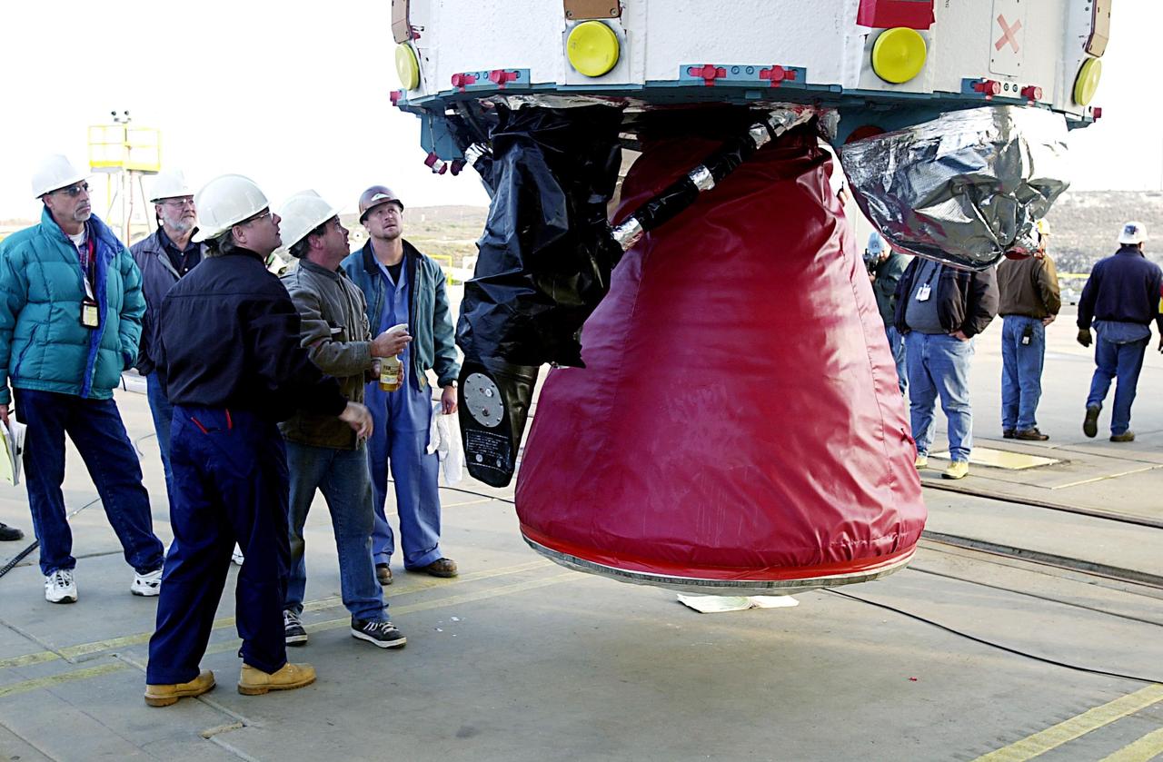 KENNEDY SPACE CENTER, FLA. - With the transporter moved from below, the first stage of the Delta II rocket is suspended in air waiting to be lifted up the tower on NASA's Space Launch Complex 2 (SLC-2), Vandenberg Air Force Base, Calif. The rocket will carry the ICESat and CHIPSat satellites into Earth orbits. ICESat is a 661-pound satellite known as Geoscience Laser Altimeter System (GLAS) that will revolutionize our understanding of ice and its role in global climate change and how we protect and understand our home planet. It will help scientists determine if the global sea level is rising or falling. It will look at the ice sheets that blanket the Earth's poles to see if they are growing or shrinking. It will assist in developing an understanding of how changes in the Earth's atmosphere and climate effect polar ice masses and global sea level. CHIPSat, a suitcase-size 131-pound satellite, will provide invaluable information into the origin, physical processes and properties of the hot gas contained in the interstellar medium. This can provide important clues about the formation and evolution of galaxies since the interstellar medium literally contains the seeds of future stars. The Delta II launch is scheduled for Jan. 11 between 4:45 p.m. - 5:30 p.m. PST.