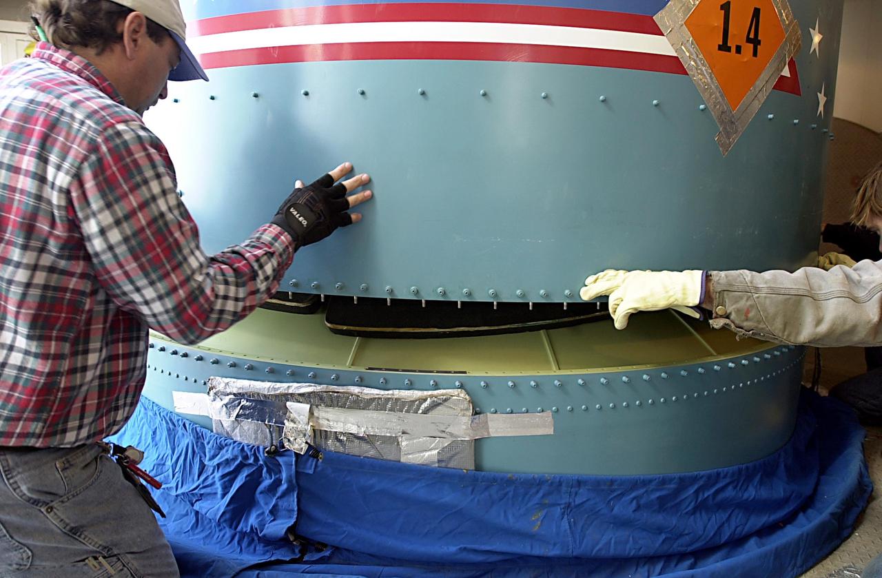 KENNEDY SPACE CENTER, FLA. - Workers on the launch tower on NASA's Space Launch Complex 2 (SLC-2), Vandenberg Air Force Base, Calif., help guide the interstage of the Delta II rocket into position for mating with the first stage. The rocket will carry the ICESat and CHIPSat satellites into Earth orbits. ICESat is a 661-pound satellite known as Geoscience Laser Altimeter System (GLAS) that will revolutionize our understanding of ice and its role in global climate change and how we protect and understand our home planet. It will help scientists determine if the global sea level is rising or falling. It will look at the ice sheets that blanket the Earth's poles to see if they are growing or shrinking. It will assist in developing an understanding of how changes in the Earth's atmosphere and climate effect polar ice masses and global sea level. CHIPSat, a suitcase-size 131-pound satellite, will provide invaluable information into the origin, physical processes and properties of the hot gas contained in the interstellar medium. This can provide important clues about the formation and evolution of galaxies since the interstellar medium literally contains the seeds of future stars. The Delta II launch is scheduled for Jan. 11 between 4:45 p.m. - 5:30 p.m. PST.