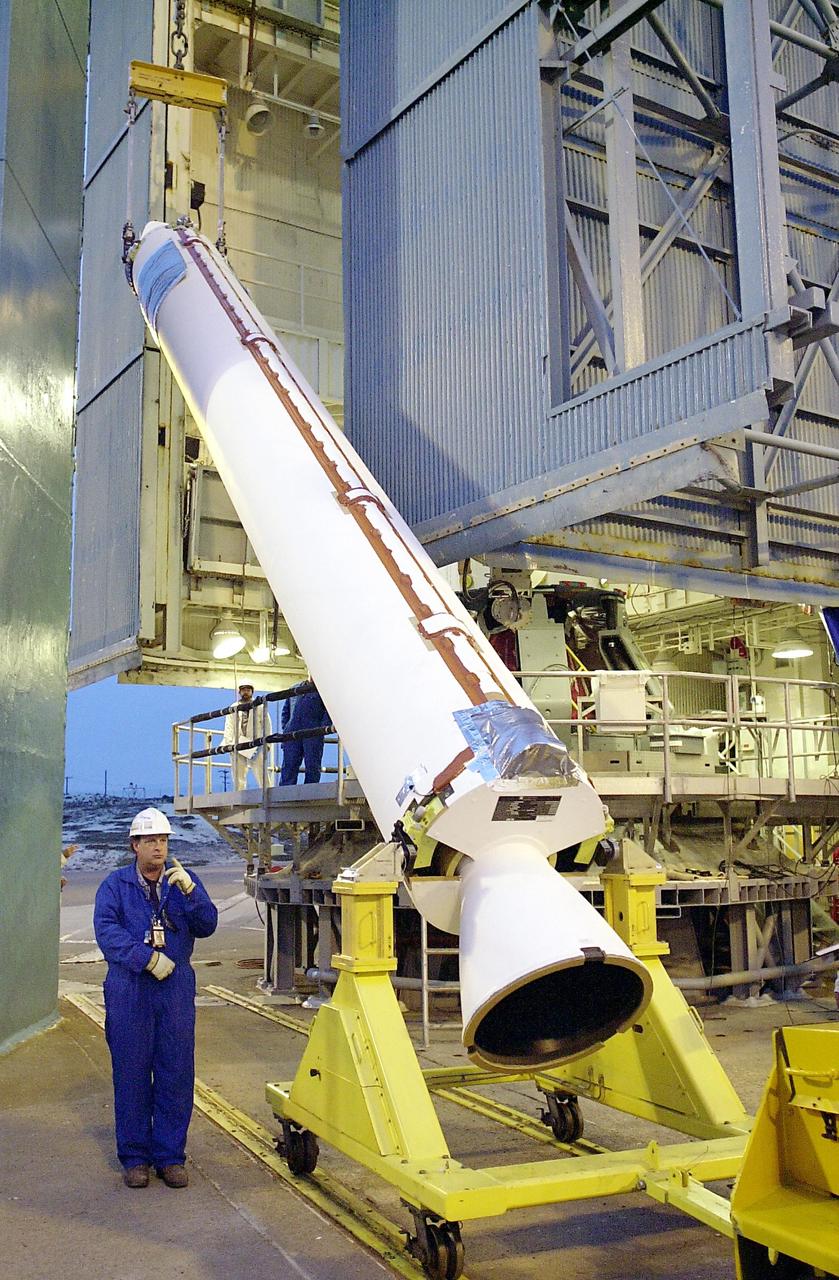 KENNEDY SPACE CENTER, FLA. - On the launch tower on NASA's Space Launch Complex 2 (SLC-2), Vandenberg Air Force Base, Calif., a solid rocket booster is lifted into an upright position for mating to a Delta II rocket. The rocket will carry the ICESat and CHIPSat satellites into Earth orbits. ICESat is a 661-pound satellite known as Geoscience Laser Altimeter System (GLAS) that will revolutionize our understanding of ice and its role in global climate change and how we protect and understand our home planet. It will help scientists determine if the global sea level is rising or falling. It will look at the ice sheets that blanket the Earth's poles to see if they are growing or shrinking. It will assist in developing an understanding of how changes in the Earth's atmosphere and climate effect polar ice masses and global sea level. CHIPSat, a suitcase-size 131-pound satellite, will provide invaluable information into the origin, physical processes and properties of the hot gas contained in the interstellar medium. This can provide important clues about the formation and evolution of galaxies since the interstellar medium literally contains the seeds of future stars. The Delta II launch is scheduled for Jan. 11 between 4:45 p.m. - 5:30 p.m. PST.