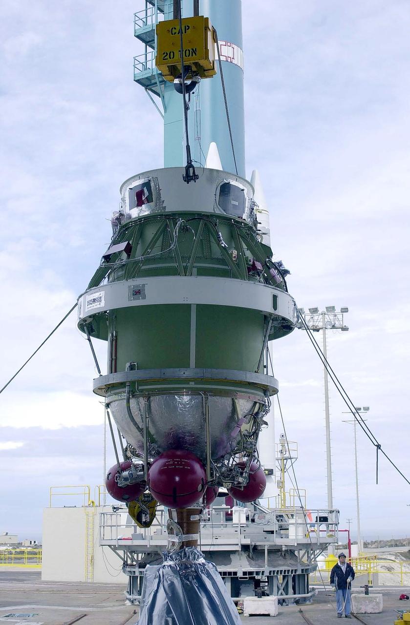 KENNEDY SPACE CENTER, FLA. - A second stage is lifted at NASA's Space Launch Complex 2 (SLC-2) at Vandenberg Air Force Base, Calif., for placement on a Delta II rocket The rocket will carry the ICESat and CHIPSat satellites into Earth orbits. The Ice, Cloud, and Land Elevation Satellite, or ICESat, is a 661-pound satellite carrying the Geoscience Laser Altimeter System (GLAS) that will revolutionize our understanding of ice and its role in global climate change and how we protect and understand our home planet. It will help scientists determine if the global sea level is rising or falling. It will look at the ice sheets that blanket the Earth's poles to see if they are growing or shrinking. It will assist in developing an understanding of how changes in the Earth's atmosphere and climate effect polar ice masses and global sea level. The Cosmic Hot Interstellar Plasma Spectrometer, or CHIPSat, a suitcase-size 131-pound satellite, will provide invaluable information into the origin, physical processes and properties of the hot gas contained in the interstellar medium. This can provide important clues about the formation and evolution of galaxies since the interstellar medium literally contains the seeds of future stars. The Delta II launch is scheduled for Jan. 11, 2003, between 4:45 p.m. - 5:30 p.m. PST.