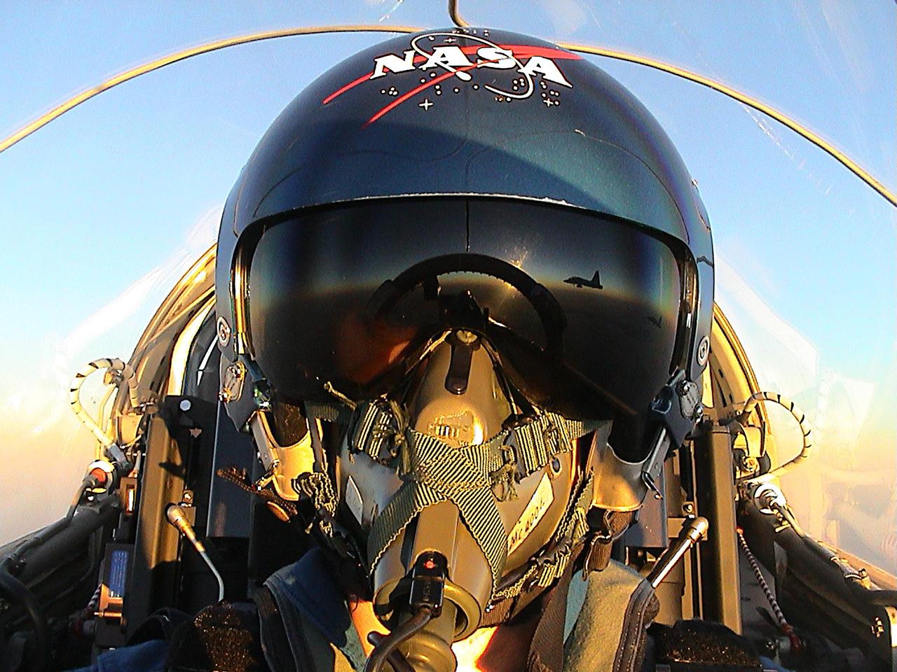 KENNEDY SPACE CENTER, FLA. --  At the conclusion of Terminal Countdown Demonstration Test activities, the STS-107 crew returns to Houston.  In the cockpit of the T-38 jet trainer is Pilot William "Willie" McCool.  Reflected in his helmet is another T-38 with other crew members. The launch of mission STS-107 is planned for Jan. 16, 2003, between 10 a.m. and 2 p.m. EST aboard Space Shuttle Columbia.   A mission devoted to research, STS-107 will include more than 80 experiments that will study Earth and space science, advanced technology development, and astronaut health and safety.  [Photo by: astronaut Willie McCool]