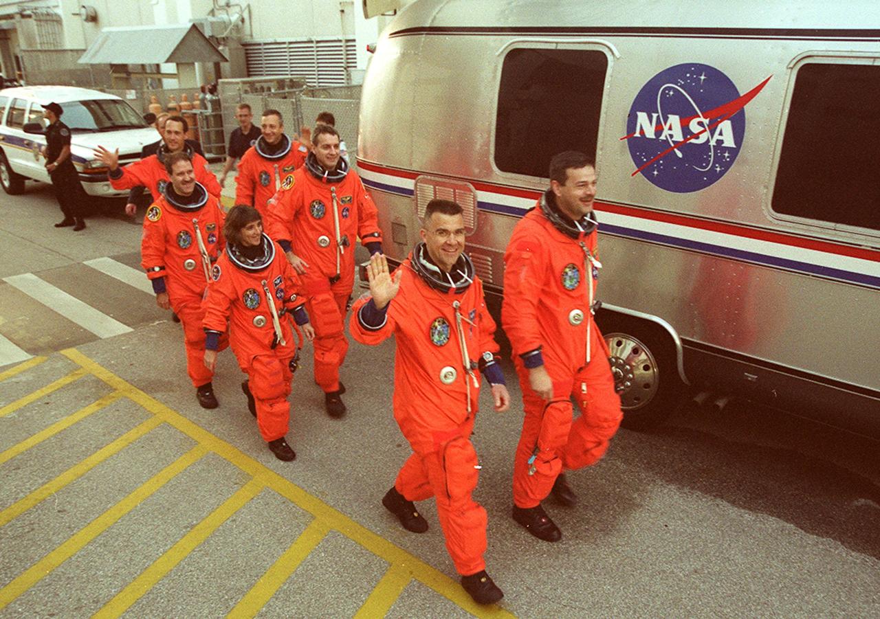 KENNEDY SPACE CENTER, FLA. --  The STS-109 crew walks toward the Astrovan for a ride to the launch pad.  Leading the way are Commander Scott Altman and Pilot Duane Carey; behind them are Mission Specialist Nancy Currie followed by Payload Commander John Grunsfeld (left) and Mission Specialist Rick Linnehan (right); in the rear are Mission Specialists James Newman and Michael Massimino.  The crew is taking part in Terminal Countdown Demonstration Test activities that include emergency egress training and a simulated countdown at the pad.  Columbia is scheduled to be launched Feb. 28 on mission STS-109, a Hubble Servicing Mission. The goal of the mission is to replace Solar Array 2 with Solar Array 3, replace the Power Control Unit, remove the Faint Object Camera and install the ACS, install the Near Infrared Camera and Multi-Object Spectrometer (NICMOS) Cooling System, and install New Outer Blanket Layer insulation.  The launch will be the first for Columbia after returning from California where it underwent extensive maintenance, inspections and enhancements. More than 100 upgrades make Columbia safer and more reliable than ever before