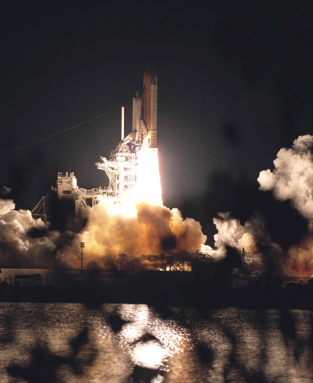 KENNEDY SPACE CENTER, Fla. -  Space Shuttle Columbia roars past the lighting mast on launch pad 39A as its fiery exhaust emblazons the pre-dawn sky and nearby water.  Both the Rotating Service Structure (left) and Fixed Service Structure are clearly defined in the brilliant light.  Liftoff of Columbia on mission STS-109 occurred at 6:22:02:08 a.m. EST (11:22:02:08 GMT). This was the 27th flight of the vehicle and 108th in the history of the Shuttle program.  The goal of the mission is the maintenance and upgrade of the Hubble Space Telescope, to be carried out in five spacewalks.  The crew comprises Commander Scott D. Altman, Pilot Duane G. Carey, Payload Commander John M. Grunsfeld, and Mission Specialists Nancy Jane Currie, Richard M. Linnehan, James H. Newman and Michael J. Massimino.  After the 11-day mission, Columbia is expected to return to KSC March 12 about 4:35 a.m. EST (09:35 GMT). 