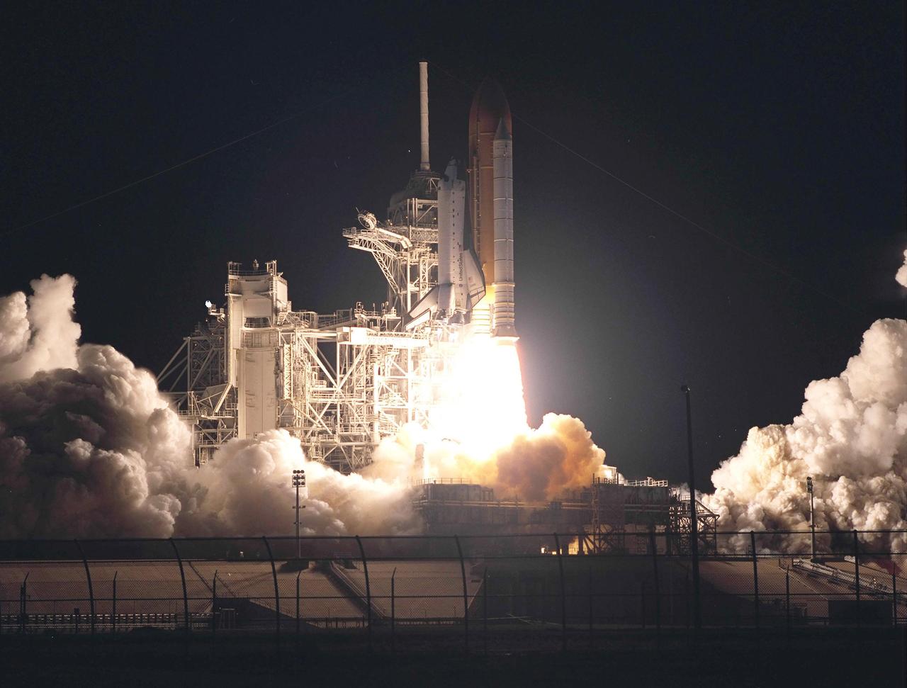 KENNEDY SPACE CENTER, Fla. - Space Shuttle Columbia's fiery exhaust illuminates Launch Pad 39A as the vehicle climbs toward its destination in space on mission STS-109.  Bathed in the white light are the Rotating Service Structure (left) and Fixed Service Structure with its 80-foot lightning mast on top.  Liftoff occurred at 6:22:02:08 a.m. EST (11:22:02:08 GMT). This was the 27th flight of the vehicle and 108th in the history of the Shuttle program.  The goal of the mission is the maintenance and upgrade of the Hubble Space Telescope, to be carried out in five spacewalks.  The crew comprises Commander Scott D. Altman, Pilot Duane G. Carey, Payload Commander John M. Grunsfeld, and Mission Specialists Nancy Jane Currie, Richard M. Linnehan, James H. Newman and Michael J. Massimino.  After the 11-day mission, Columbia is expected to return to KSC March 12 about 4:35 a.m. EST (09:35 GMT). 