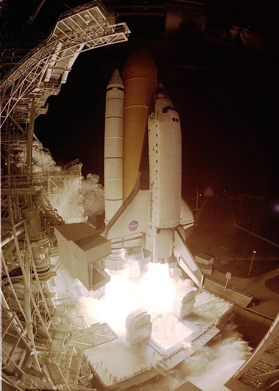 KENNEDY SPACE CENTER, Fla. - A fish-eye lens gives a different perspective to the launch of Space Shuttle Columbia on mission STS-109.  Torrents of water spread over the Mobile Launcher Platform from 12-foot rainbirds and into the flame trench as part of the sound suppression system.   Acoustical levels reach their peak when the Space Shuttle is about 300 feet above the MLP.  At left of the Shuttle is the Fixed Service Structure with the Orbiter Access Arm and White Room, seen in the foreground.  Liftoff of Columbia occurred at 6:22:02:08 a.m. EST (11:22:02:08 GMT). This was the 27th flight of the vehicle and 108th in the history of the Shuttle program.  The goal of the mission is the maintenance and upgrade of the Hubble Space Telescope, to be carried out in five spacewalks.  The crew comprises Commander Scott D. Altman, Pilot Duane G. Carey, Payload Commander John M. Grunsfeld, and Mission Specialists Nancy Jane Currie, Richard M. Linnehan, James H. Newman and Michael J. Massimino.  After the 11-day mission, Columbia is expected to return to KSC March 12 about 4:35 a.m. EST (09:35 GMT)