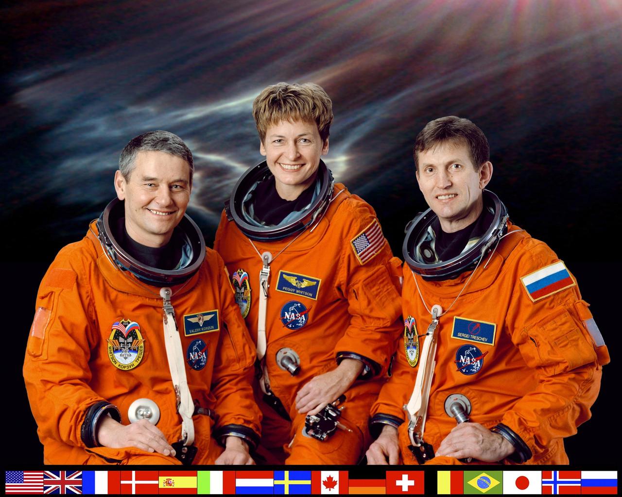JOHNSON SPACE CENTER, HOUSTON, TEXAS -- EXPEDITION FIVE CREW PORTRAIT --- (JSC ISS05-5-002) -- Cosmonaut Valeri G. Korzun (left), Expedition Five mission commander; astronaut Peggy A. Whitson and cosmonaut Sergei Y. Treschev, both flight engineers, attired in training versions of the shuttle launch and entry suit, pause from their training schedule for a crew portrait. The three will be launched to the International Space Station (ISS) in early spring of this year aboard the Space Shuttle Atlantis. Korzun and Treschev represent the Russian Aviation and Space Agency (Rosaviakosmos)