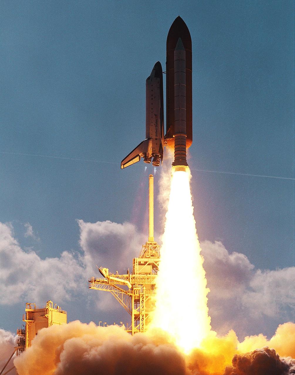 KENNEDY SPACE CENTER, FLA. - Space Shuttle Atlantis clears the lightning mast as it hurtles into the afternoon sky from Launch Pad 39B on mission STS-110.  The mast is on the top of the Fixed Service Structure.  Flames from the solid rocket booster look like an inverted torch. Liftoff occurred at 4:44:19 p.m. EDT (20:41:19 GMT).  Carrying the S0 Integrated Truss Structure and Mobile Transporter, STS-110 is the 13th assembly flight to the International Space Station