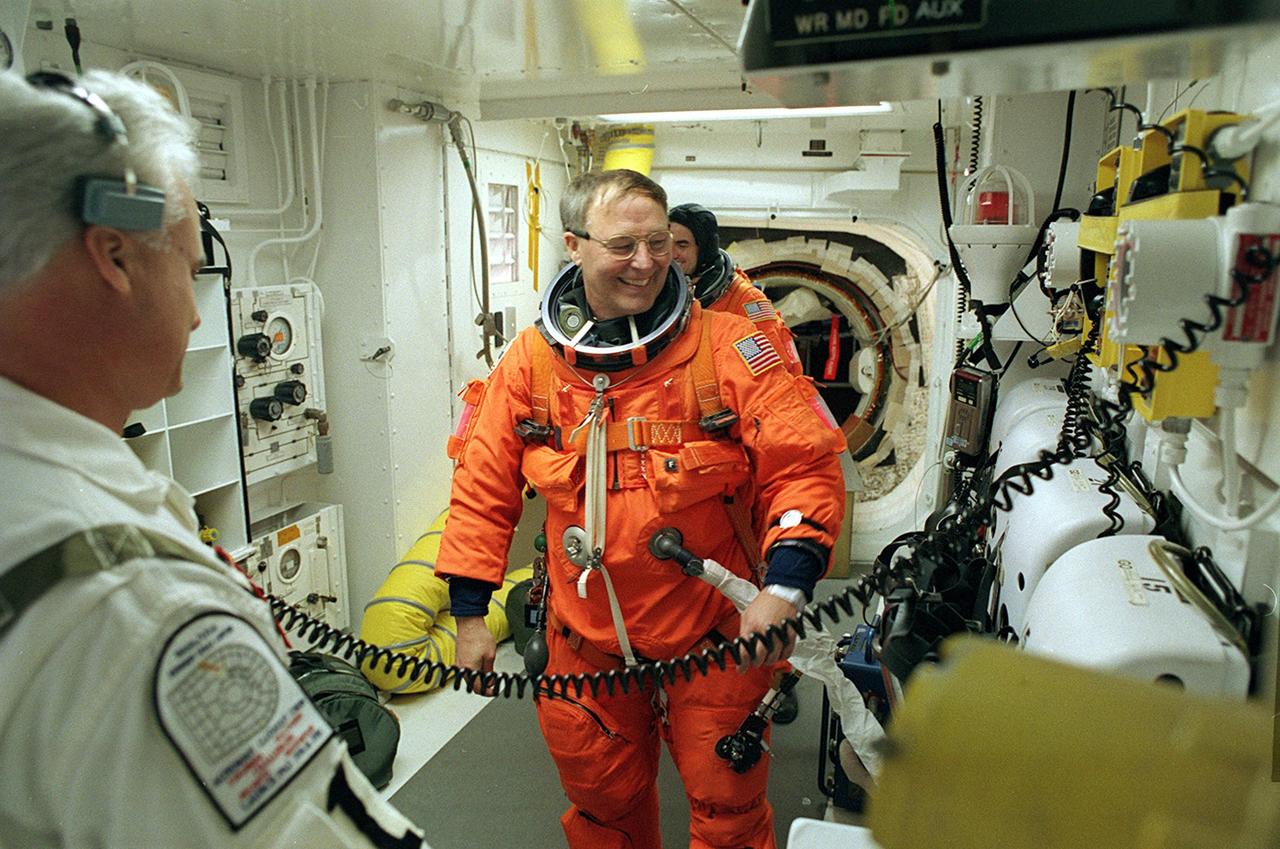 KENNEDY SPACE CENTER, FLA. - Jerry Ross jokes with the Closeout Crew in the White Room as he prepares to enter Space Shuttle Atlantis for launch.  The White Room provides entry into the cockpit area of the orbiter.  The 13th assembly flight to the International Space Station, STS-110 is carrying the S0 Integrated Truss Structure and Mobile Transporter (MT).  On the 11-day mission, astronauts, including Ross, will make four spacewalks to attach the S0 truss, which will become the backbone of the Space Station, to the U.S. Lab, "Destiny."   The  MT, a space "railcar," is attached to the truss segment and will make its debut run during the flight.  Ross is making his seventh Shuttle flight, a new record in the history of the Shuttle program, and will complete his ninth spacewalk, also a record.  Launch is scheduled for 4:40 p.m. EDT (20:40 GMT)