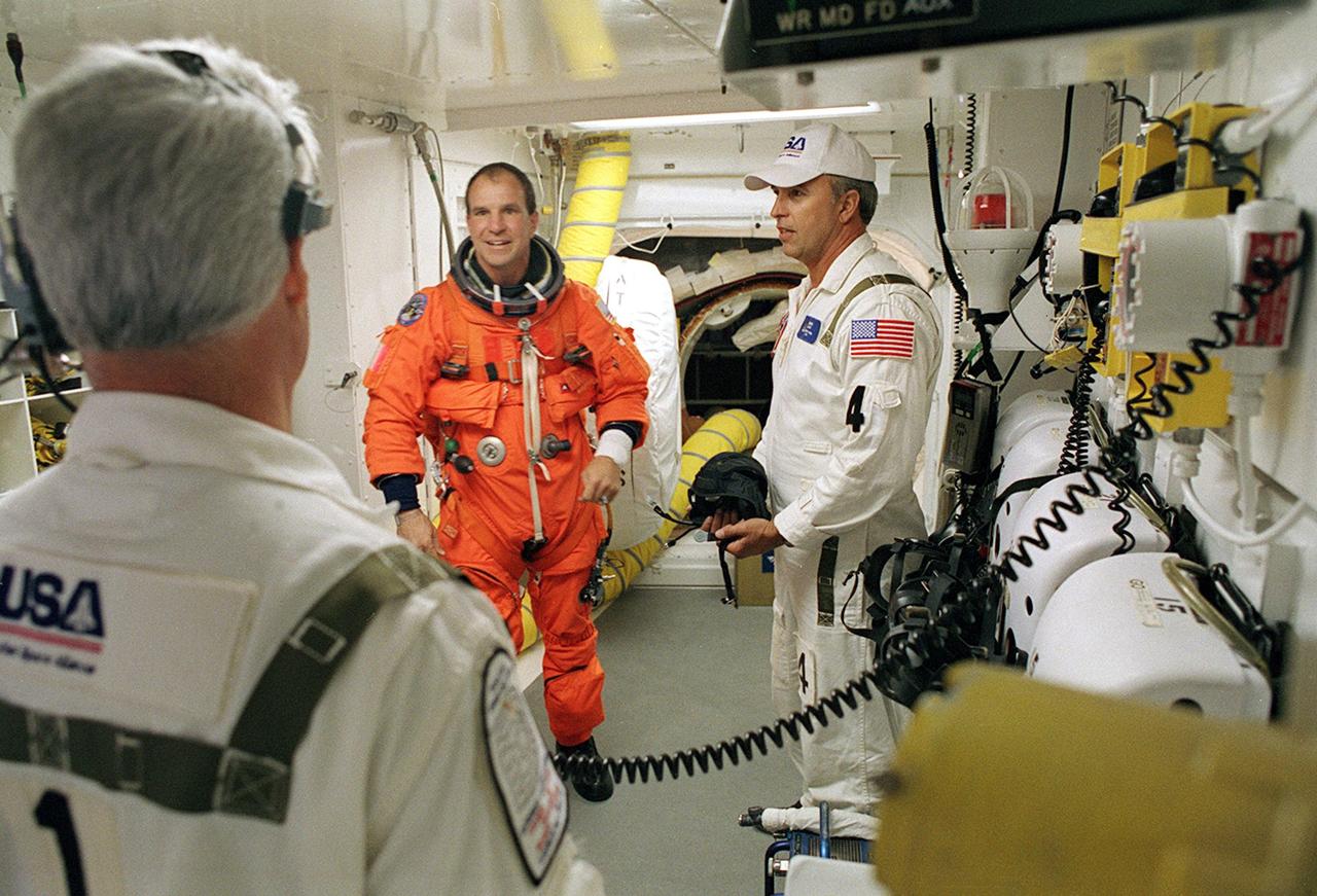 KENNEDY SPACE CENTER, FLA. - STS-110 Commander Michael Bloomfield talks to members of the Closeout Crew in the White Room before he enters entering Space Shuttle Atlantis for launch. The White Room provides entry into the cockpit area of the orbiter. This is Bloomfield's third Shuttle flight. STS-110 is carrying the S0 Integrated Truss Structure and Mobile Transporter (MT) on this 13th assembly flight to the International Space Station. On the 11-day mission, astronauts will make four spacewalks to attach the S0 truss, which will become the backbone of the Space Station, to the U.S. Lab, "Destiny." The MT, a space "railcar," is attached to the truss segment and will make its debut run during the flight. Launch is scheduled for 4:40 p.m. EDT (20:40 GMT)