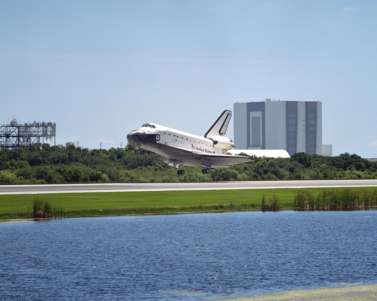 KENNEDY SPACE CENTER, FLA. -  With the Vehicle Assembly Building in the background, Atlantis is ready to touch down on runway 33 after completing the 10-day, 19-hour, 4.5-million mile mission STS-110 to the International Space Station.   The orbiter carries the returning crew Commander Michael Bloomfield, Pilot Stephen Frick and Mission Specialists Jerry Ross, Steven Smith, Ellen Ochoa, Lee Morin and Rex Walheim.  Main gear touchdown was 12:26:57 p.m. EDT, nose gear touchdown was 12:27:09 p.m. and wheel stop was 12:28:07 p.m.  The crew delivered and installed the S0 truss, which will support cooling and power systems essential for the addition of future international laboratories, on the Station