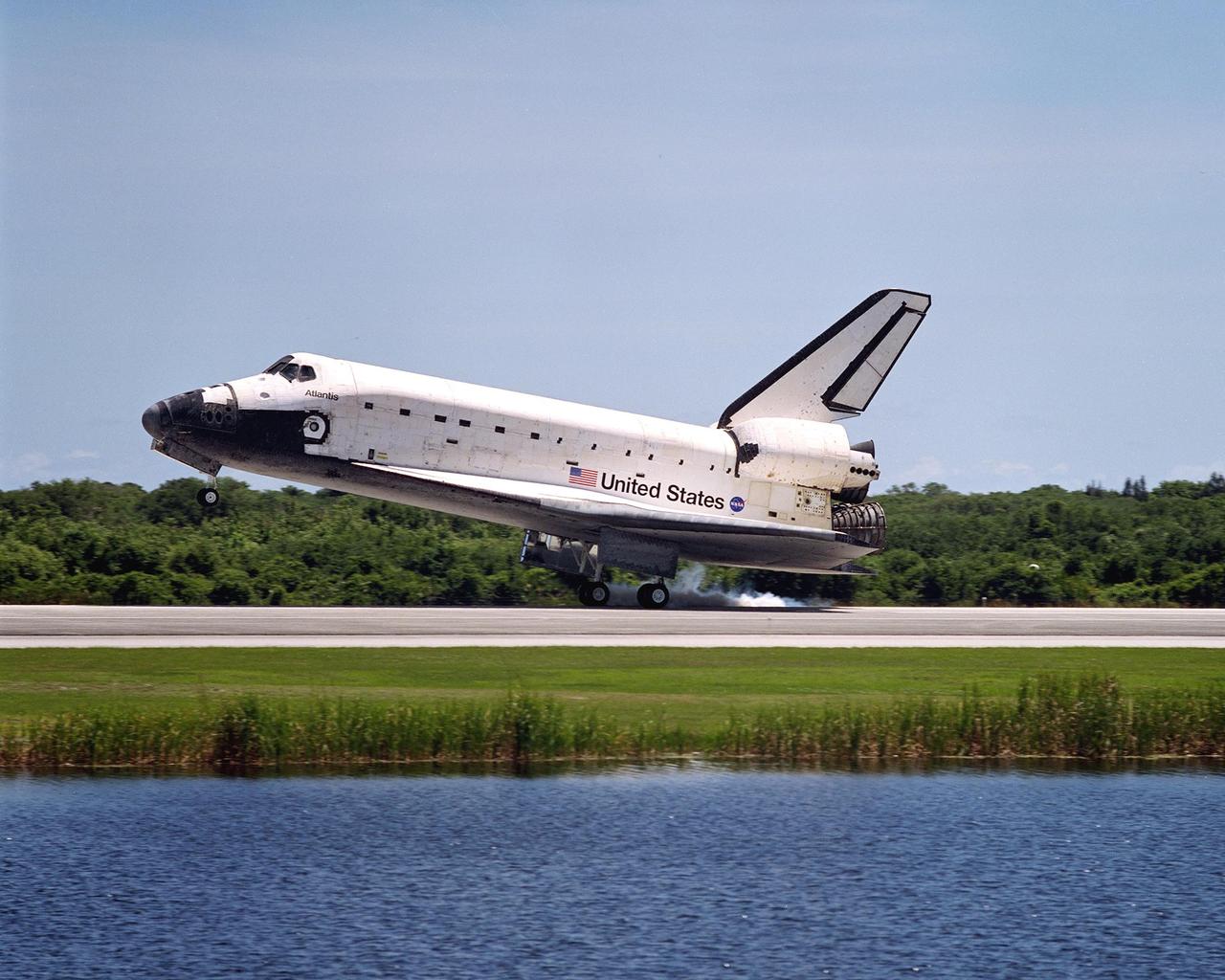 KENNEDY SPACE CENTER, FLA. - Atlantis kicks up dust as it touches down on runway 33 after completing the 10-day, 19-hour, 4.5-million mile mission STS-110 to the International Space Station.   The orbiter carries the returning crew Commander Michael Bloomfield, Pilot Stephen Frick and Mission Specialists Jerry Ross, Steven Smith, Ellen Ochoa, Lee Morin and Rex Walheim.  Main gear touchdown was 12:26:57 p.m. EDT, nose gear touchdown was 12:27:09 p.m. and wheel stop was 12:28:07 p.m.  The crew delivered and installed the S0 truss, which will support cooling and power systems essential for the addition of future international laboratories, on the Station