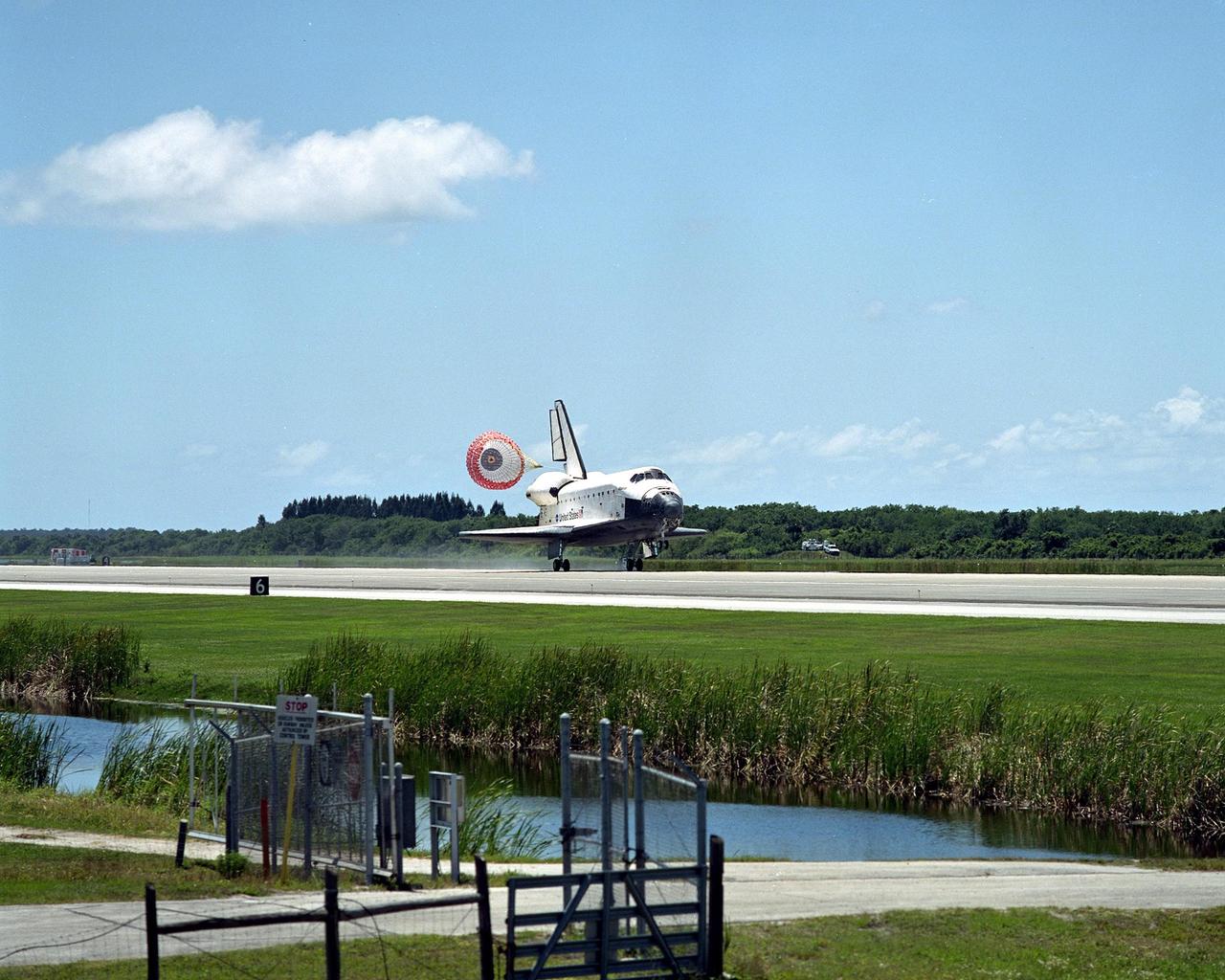 KENNEDY SPACE CENTER, FLA. - Atlantis is slowed during landing by the open drag chute behind the tail.  The orbiter and crew -- Commander Michael Bloomfield, Pilot Stephen Frick and Mission Specialists Jerry Ross, Steven Smith, Ellen Ochoa, Lee Morin and Rex Walheim - have just completed the 10-day, 19-hour, 4.5-million mile mission STS-110 to the International Space Station.  Main gear touchdown was 12:26:57 p.m. EDT, nose gear touchdown was 12:27:09 p.m. and wheel stop was 12:28:07 p.m.  The crew delivered and installed the S0 truss, which will support cooling and power systems essential for the addition of future international laboratories, on the Station