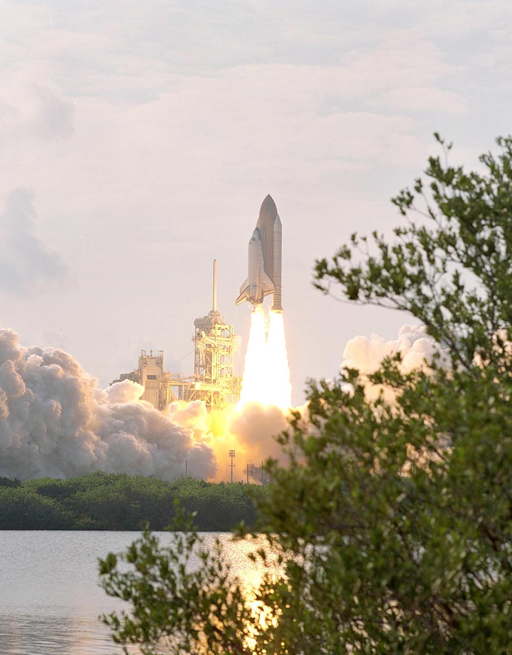 KENNEDY SPACE CENTER, FLA. -  Viewed from across the nearby water, the launch of Space Shuttle Endeavour fills the horizon.  Liftoff at 5:22:49 p.m.  EDT sent Endeavour and its crew of four, plus the Expedition 5 crew, on its way to the International space Station on mission STS-111. This mission marks the 14th Shuttle flight to the International Space Station and the third Shuttle mission this year. Mission STS-111 is the 18th flight of Endeavour and the 110th flight overall in NASA's Space Shuttle program