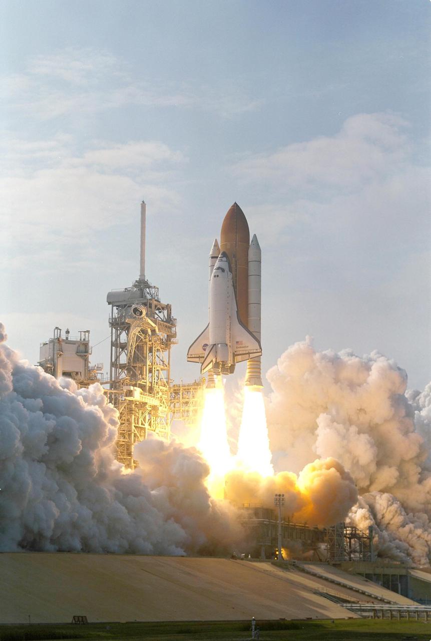 KENNEDY SPACE CENTER, FLA. - Clouds of smoke and steam billow across Launch Pad 39A as Space Shuttle Endeavour roars toward space on mission STS-111 to the International Space Station. Liftoff occurred at 5:22:49 p.m. EDT. The STS-111 crew includes Commander Kenneth Cockrell, Pilot Paul Lockhart, and Mission Specialists Franklin Chang-Diaz and Philippe Perrin (CNES), as well as the Expedition Five crew members Valeri Korzun, Peggy Whitson and Sergei Treschev. This mission marks the 14th Shuttle flight to the International Space Station and the third Shuttle mission this year. Mission STS-111 is the 18th flight of Endeavour and the 110th flight overall in NASA's Space Shuttle program