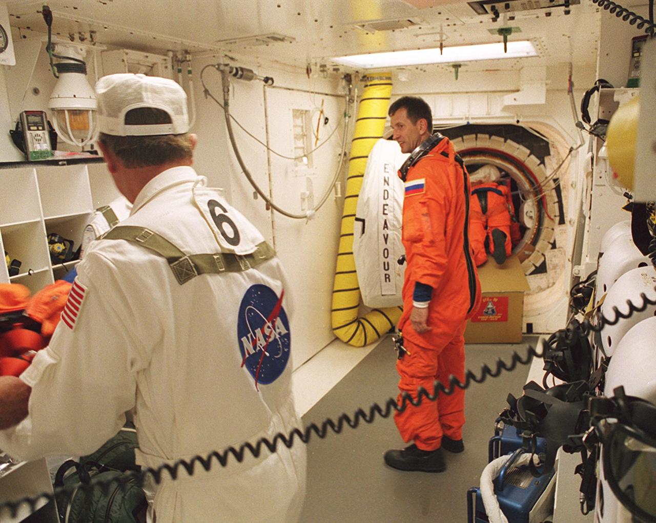KENNEDY SPACE CENTER, FLA. -- Expedition Five cosmonaut Sergei Treschev talks to members of the Closeout Crew in the White Room before entering Space Shuttle Endeavour for launch of mission STS-111. The White Room, at the end of the Orbiter Access Arm, provides entry into the cockpit area of the orbiter. Other crew members are Commander Kenneth Cockrell, Pilot Paul Lockhart, Mission Specialists Franklin Chang-Diaz and Philippe Perrin (CNES), and Expedition Five Commander Valeri Korzun and astronaut Peggy Whitson. This mission, a utilization flight, marks the 14th Shuttle flight to the International Space Station and the third Shuttle mission this year. Mission STS-111 is the 18th flight of Endeavour and the 110th flight overall in NASA's Space Shuttle program