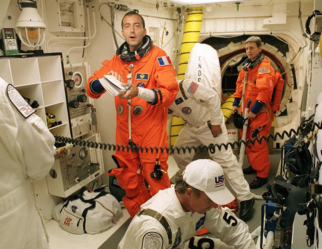 KENNEDY SPACE CENTER, FLA. -- STS-111 Mission Specialist Philippe Perrin (CNES) talks to members of the Closeout Crew in the White Room before entering Space Shuttle Endeavour for launch. Expedition Five astronaut Peggy Whitson awaits her turn to enter the orbiter in the background. The White Room, at the end of the Orbiter Access Arm, provides entry into the cockpit area of the orbiter. Other crew members are Commander Kenneth Cockrell, Pilot Paul Lockhart and Mission Specialist Franklin Chang-Diaz, and Expedition Five Commander Valeri Korzun and cosmonaut Sergei Treschev. This mission, a utilization flight, marks the 14th Shuttle flight to the International Space Station and the third Shuttle mission this year. Mission STS-111 is the 18th flight of Endeavour and the 110th flight overall in NASA's Space Shuttle program