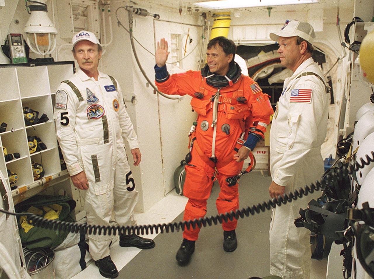 KENNEDY SPACE CENTER, FLA. -- STS-111 Mission Specialist Franklin Chang-Diaz waves to a member of the Closeout Crew in the White Room before entering Space Shuttle Endeavour for launch. The White Room, at the end of the Orbiter Access Arm, provides entry into the cockpit area of the orbiter. Other crew members are Commander Kenneth Cockrell, Pilot Paul Lockhart and Mission Specialist Philippe Perrin (CNES) , and Expedition Five Commander Valeri Korzun, astronaut Peggy Whitson and cosmonaut Sergei Treschev. This mission, a utilization flight, marks the 14th Shuttle flight to the International Space Station and the third Shuttle mission this year. Mission STS-111 is the 18th flight of Endeavour and the 110th flight overall in NASA's Space Shuttle program
