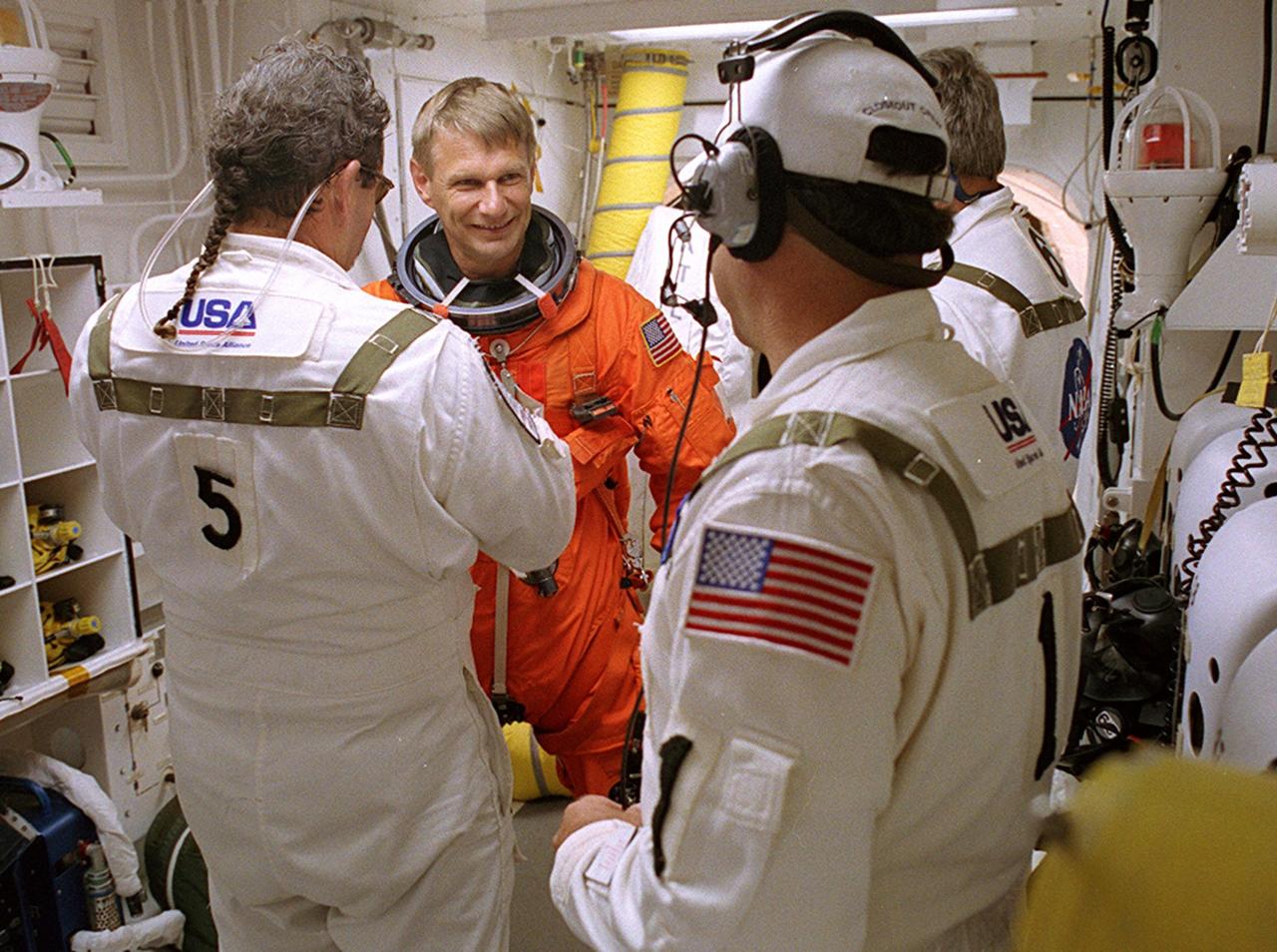 KENNEDY SPACE CENTER, FLA. - -- In the White Room at Launch Pad 39B, STS-112 Mission Specialist Piers J. Sellers, Ph.D., receives assistance with his spacesuit before boarding Space Shuttle Atlantis.  Liftoff is schedued for 3:46 p.m. EDT. Along with a crew of six, Atlantis will carry the S1 Integrated Truss Structure and the Crew and Equipment Translation Aid (CETA) Cart A to the International Space Station (ISS). The CETA is the first of two human-powered carts that will ride along the ISS railway, providing mobile work platforms for future spacewalking astronauts. On the 11-day mission, three spacewalks are planned to attach the S1 truss. 