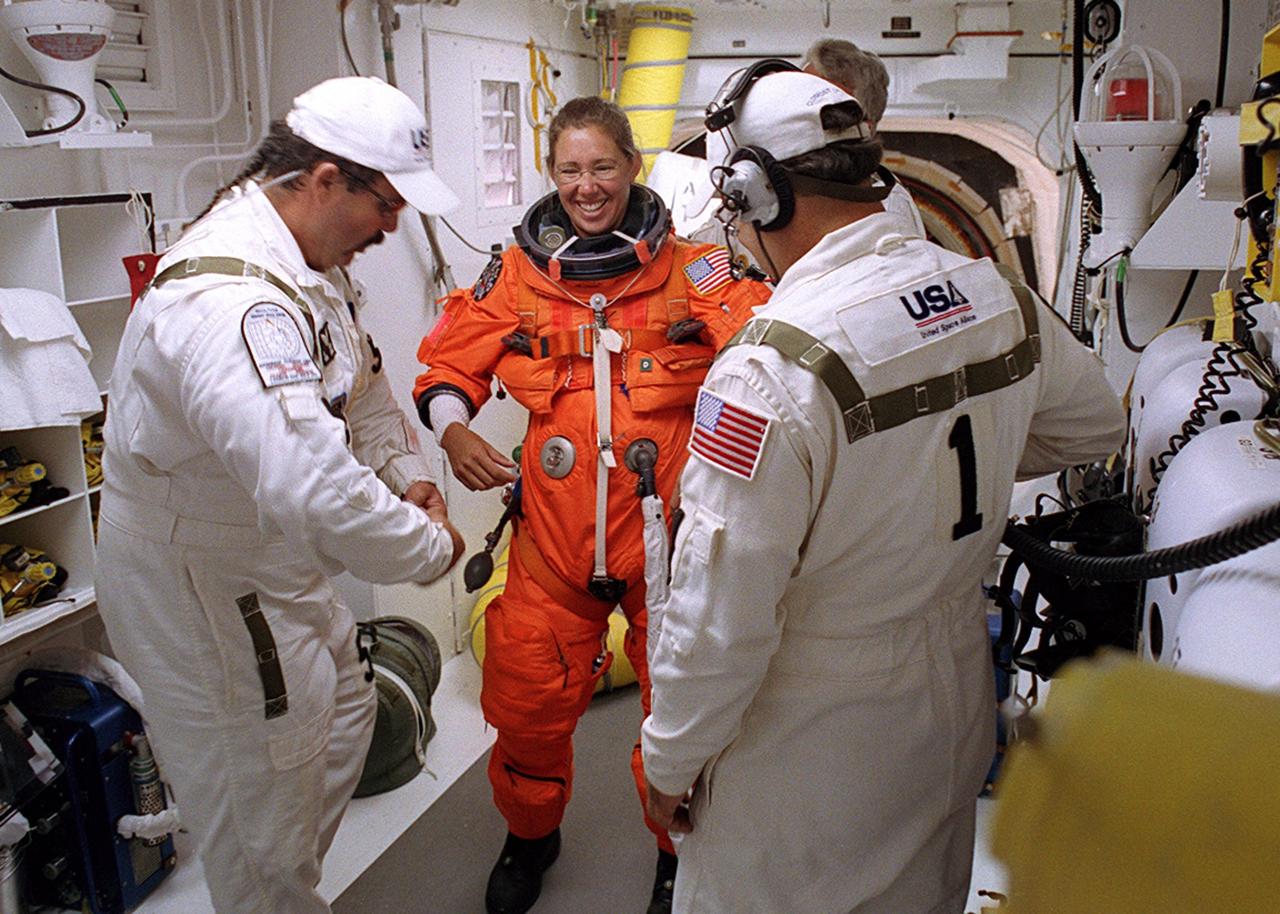 KENNEDY SPACE CENTER, FLA. - -- In the White Room at Launch Pad 39B, STS-112 Mission Specialist Sandra H. Magnus, Ph.D., receives assistance with her spacesuit before boarding Space Shuttle Atlantis.  Liftoff is schedued for 3:46 p.m. EDT. Along with a crew of six, Atlantis will carry the S1 Integrated Truss Structure and the Crew and Equipment Translation Aid (CETA) Cart A to the International Space Station (ISS). The CETA is the first of two human-powered carts that will ride along the ISS railway, providing mobile work platforms for future spacewalking astronauts. On the 11-day mission, three spacewalks are planned to attach the S1 truss. 