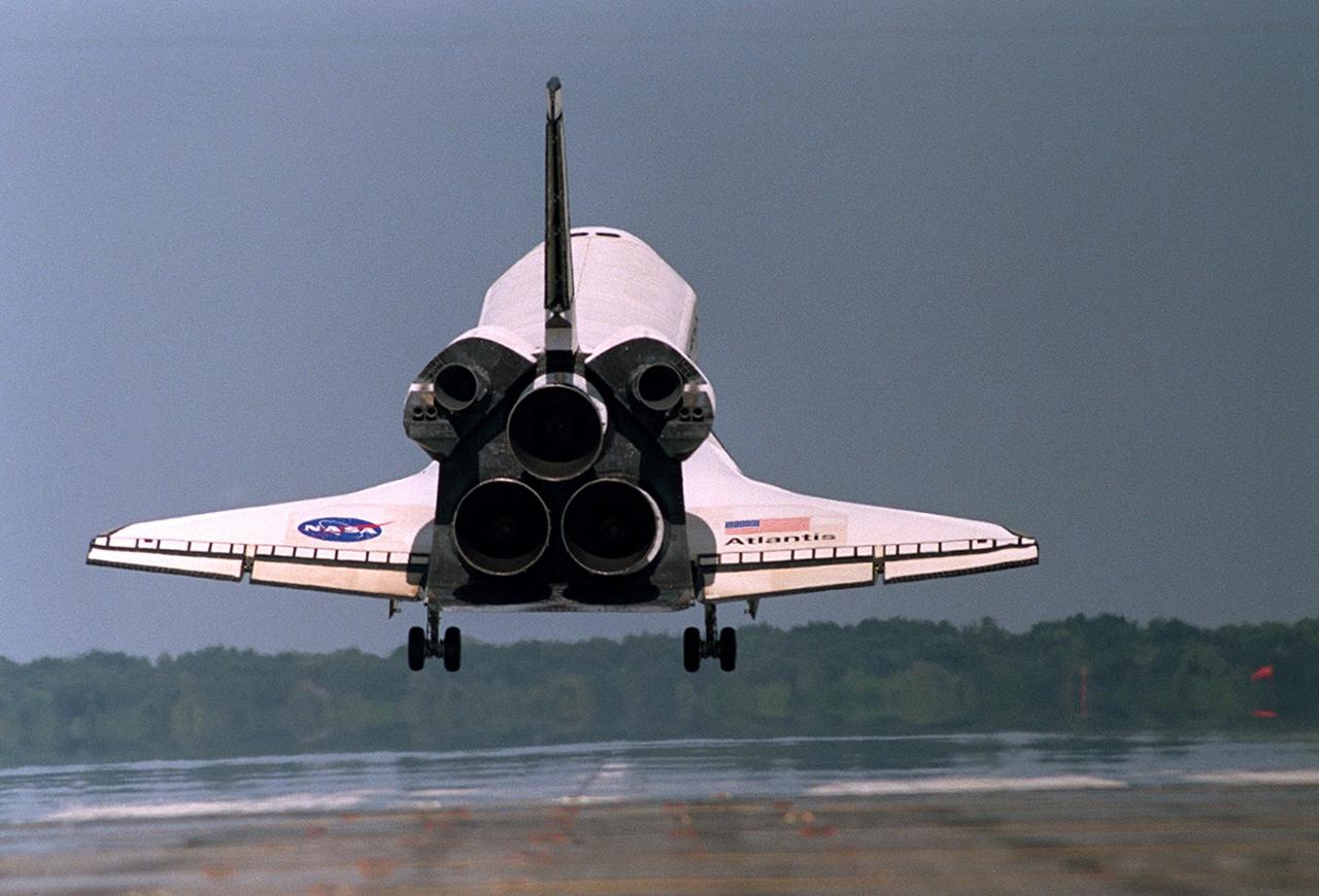 KENNEDY SPACE CENTER, FLA. - Atlantis kicks up dust as it touches down on runway 33 at the KSC Shuttle Landing Facility after completing its 11-day mission to the International Space Station. Aboard is the STS-112 crew comprising Commander Jeffrey Ashby, Pilot Pamela Melroy and Mission Specialists David Wolf, Sandra Magnus, Piers Sellers and Fyodor Yurchikhin. Main gear touchdown occurred at 11:43:40 a.m. EDT; nose gear touchdown at 11:43:48 a.m.; and wheel stop at 11:44:35 a.m. Mission elapsed time was 10:19:58:44.  STS-112 expanded the size of the Station with the addition of the S1 truss segment.   This was the 60th landing at KSC in the history of the Shuttle program.