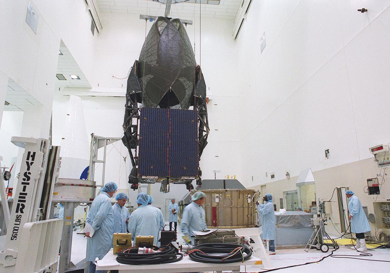 KENNEDY SPACE CENTER, FLA. --  Workers supervise the move of the suspended TDRS-J spacecraft towards a workstand in the Spacecraft Assembly and Encapsulation Facility-2 (SAEF-2) for final checkout and processing before launch, currently targeted for Nov. 20. TDRS-J is the third in the current series of three Tracking and Data Relay Satellites designed to replenish the existing on-orbit fleet of six spacecraft, the first of which was launched in 1983. The Tracking and Data Relay Satellite System is the primary source of space-to-ground voice, data and telemetry for the Space Shuttle. It also provides communications with the International Space Station and scientific spacecraft in low-earth orbit, such as the Hubble Space Telescope, and launch support for some expendable vehicles. This new advanced series of satellites will extend the availability of TDRS communications services until approximately 2017. 