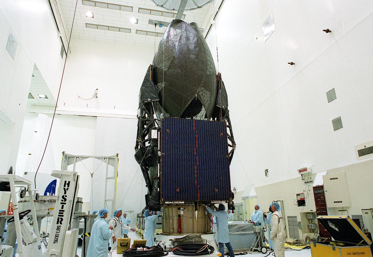KENNEDY SPACE CENTER, FLA. --  Workers supervise the placement of the TDRS-J spacecraft onto a workstand in the Spacecraft Assembly and Encapsulation Facility-2 (SAEF-2) for final checkout and processing before launch, currently targeted for Nov. 20. TDRS-J is the third in the current series of three Tracking and Data Relay Satellites designed to replenish the existing on-orbit fleet of six spacecraft, the first of which was launched in 1983. The Tracking and Data Relay Satellite System is the primary source of space-to-ground voice, data and telemetry for the Space Shuttle. It also provides communications with the International Space Station and scientific spacecraft in low-earth orbit, such as the Hubble Space Telescope, and launch support for some expendable vehicles. This new advanced series of satellites will extend the availability of TDRS communications services until approximately 2017. 