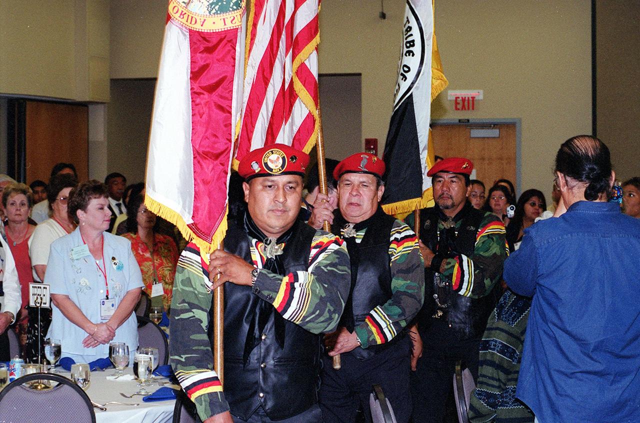 KENNEDY SPACE CENTER, FLA. -- The Seminole Native American Veterans Color Guard (Seminole Flag, U.S. Flag, and State of Florida Flag) enter the Debus Conference Center in the KSC Visitor Complex during a dinner honoring astronaut John B. Herrington, the first tribally enrolled Native American astronaut to fly on a Shuttle mission.  Herrington is a Mission Specialist on STS-113.  In addition to the dinner at KSC, several hundred Native Americans from around the country attended a symposium in Orlando commemorating the launch event.   The Native Americans, many of them Chickasaw, were here to honor John, who is a Chickasaw from Oklahoma.   