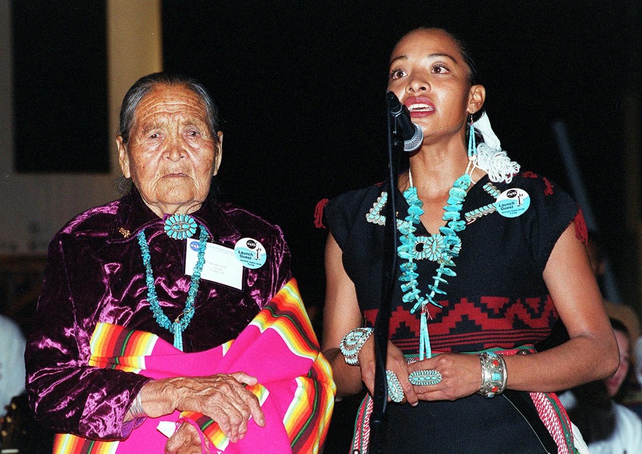 KENNEDY SPACE CENTER, FLA. --  During a pre-launch Native American ceremony, Radmilla Cody (right) , the 2001 Miss Navaho Nation, sings the "Star Spangled Banner" in her native language.  With her is her grandmother.  The ceremony was part of several days' activities commemorating John B. Herrington as the first tribally enrolled Native American astronaut to fly on a Shuttle mission. Herrington is a Mission Specialist on STS-113.      