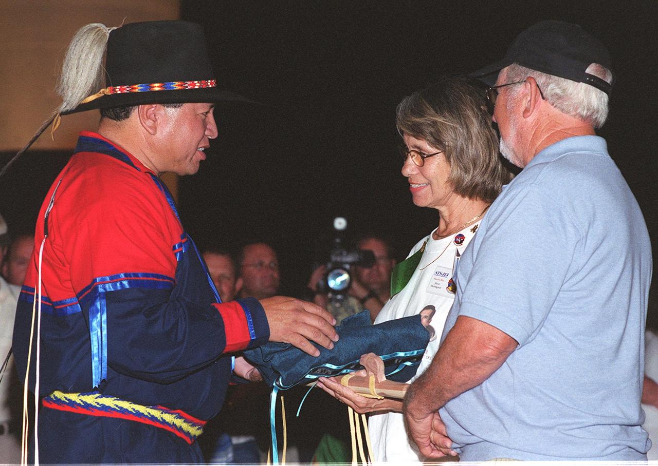 KENNEDY SPACE CENTER, FLA. -- Chickasaw Nation Cultural Resources Director Haskell Alexander (left) presents a gift to Joyce and James Herrington, parents of John Herrington, mission specialist on mission STS-113.  Herrington is the first Native American to be going into space.