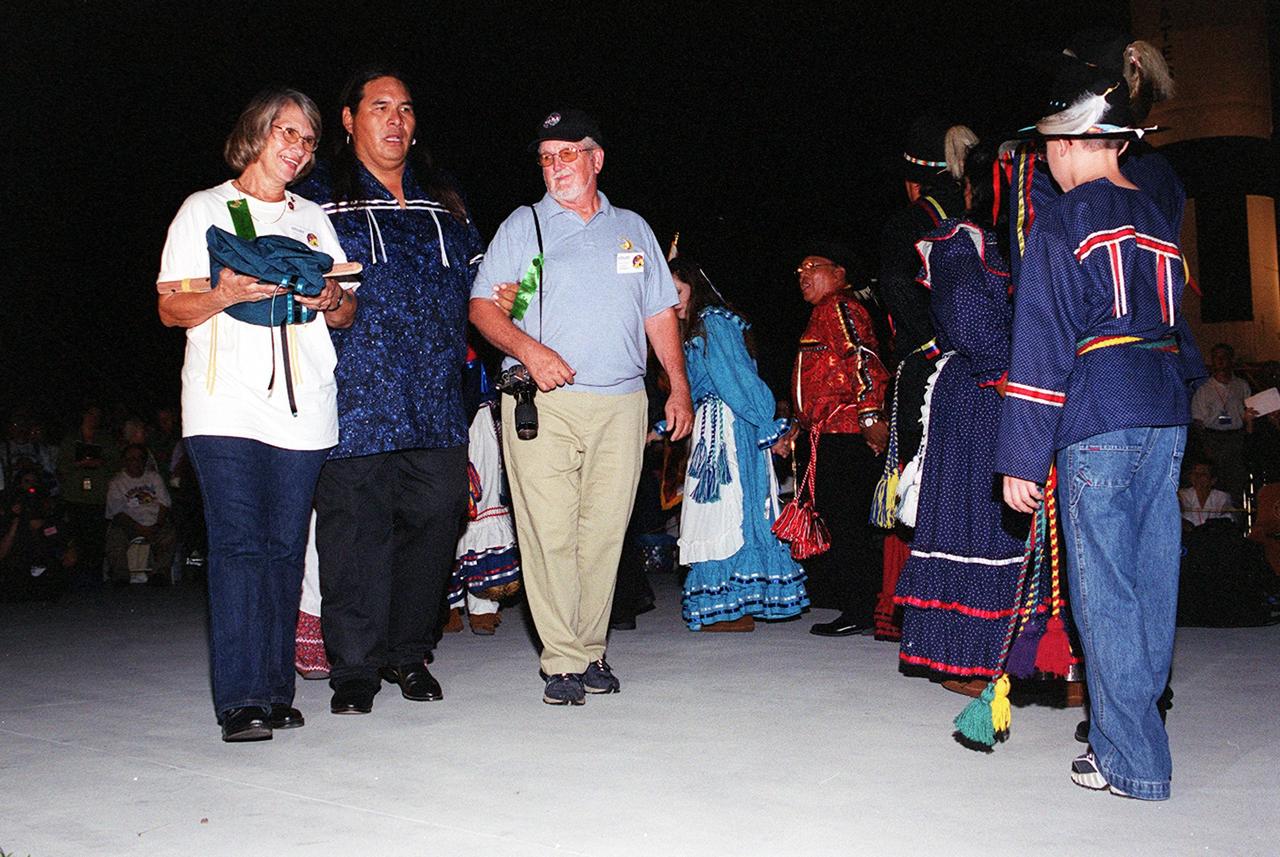KENNEDY SPACE CENTER, FLA. - Chickasaw Dance troupe member Tim Harjo (second from left) leads Joyce and James Herrington in a dance honoring their son, STS-113 Mission Specialist John Herrington.  The dance was part of a Native American ceremony at the Rocket Garden in the KSC Visitor Complex commemorating  Herrington as the first tribally enrolled Native American astronaut to fly on a Shuttle mission.  