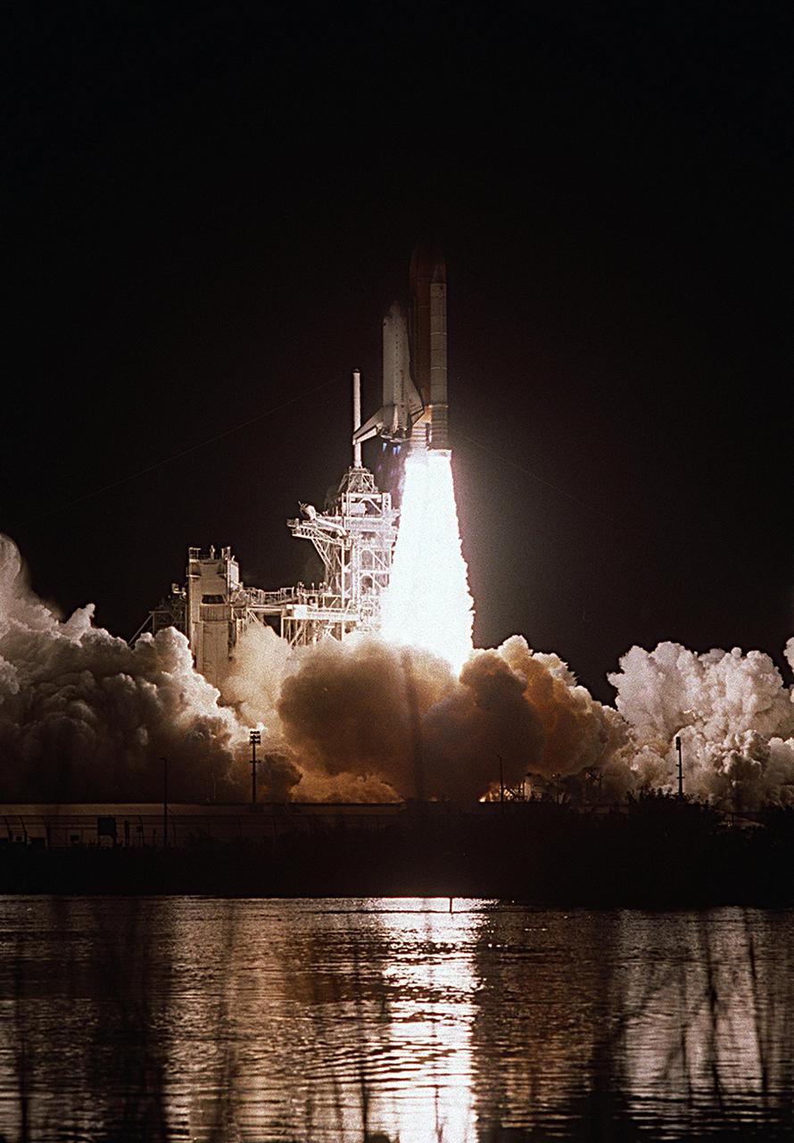 KENNEDY SPACE CENTER, FLA. -- Space Shuttle Endeavour, painting a swath of light on nearby water, blazes into the night sky on mission STS-113. Liftoff from Launch Pad 39A occurred ontime at 7:49:47 p.m. EST. The launch is the 19th for Endeavour, and the 112th flight in the Shuttle program. Mission STS-113 is the 16th assembly flight to the International Space Station, carrying another structure for the Station, the P1 integrated truss. Also onboard are the Expedition 6 crew, who will replace Expedition 5. Endeavour is scheduled to land at KSC after an 11-day journey.